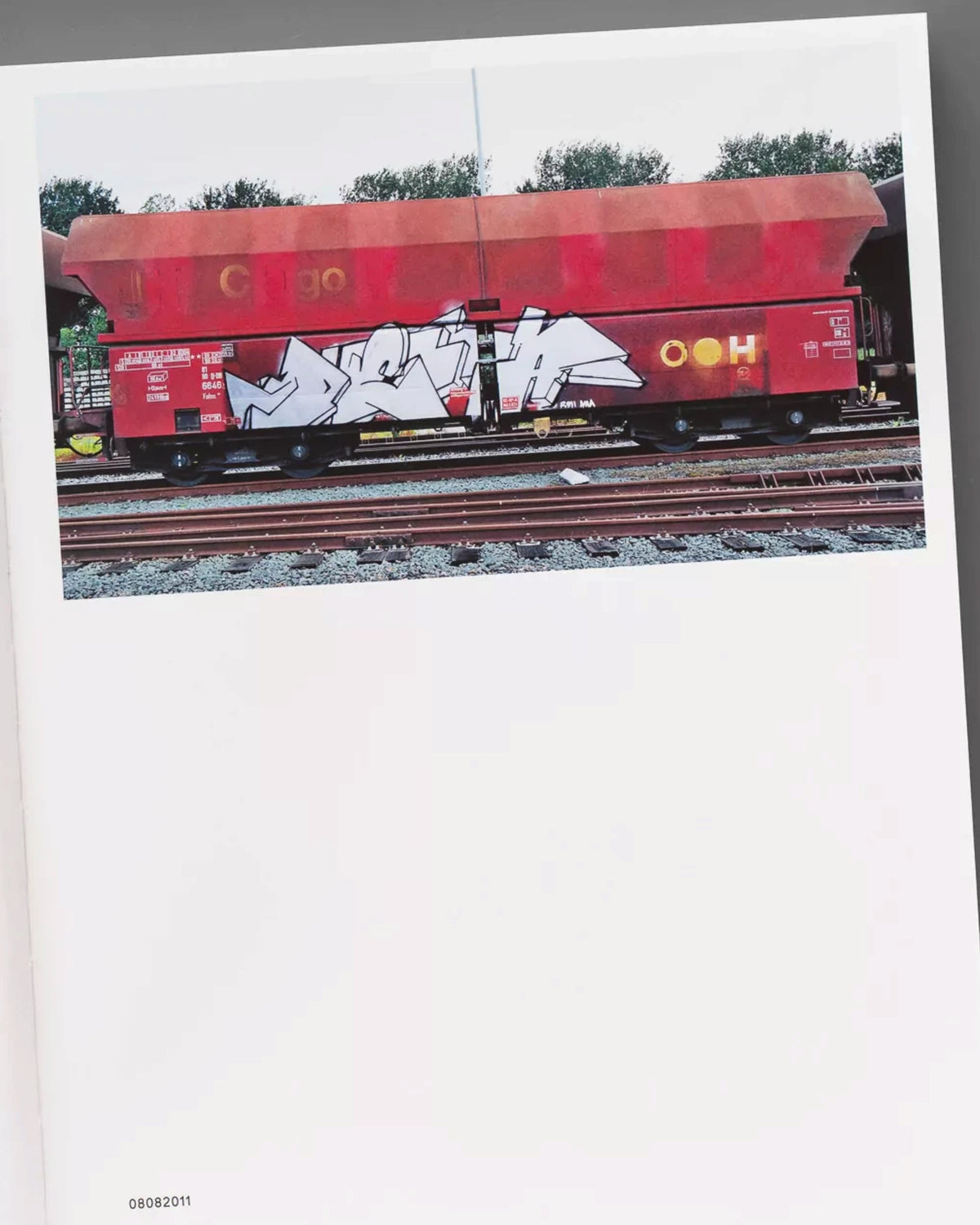 A page from the Astrofat book 121/183 by Boris DELTA Tellegen showing a photograph of a graffiti-painted freight train
