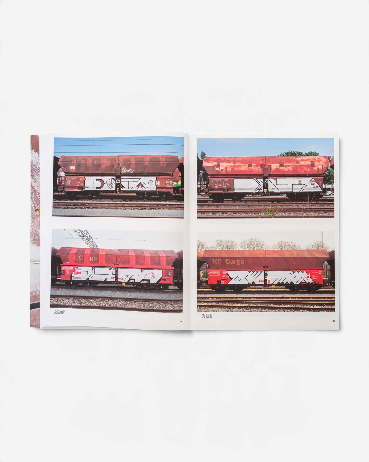 Astrofat book 121/183 by Boris DELTA Tellegen showing photographs of graffiti on red-brown DB cargo train cars.