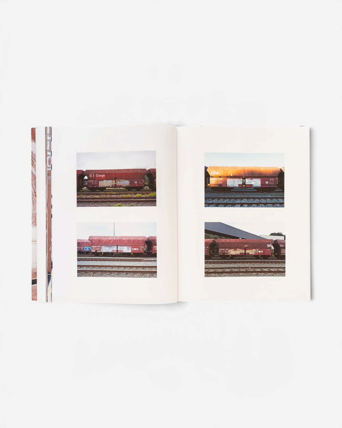 Astrofat 121/183 book by Boris DELTA Tellegen showing photographs of graffiti on red-brown cargo train cars.