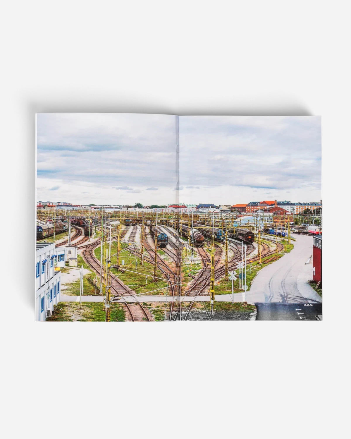 Astrofat 136 Minutes of Malmö zine open to a spread showing a wide aerial view of the Malmö freight train yard.