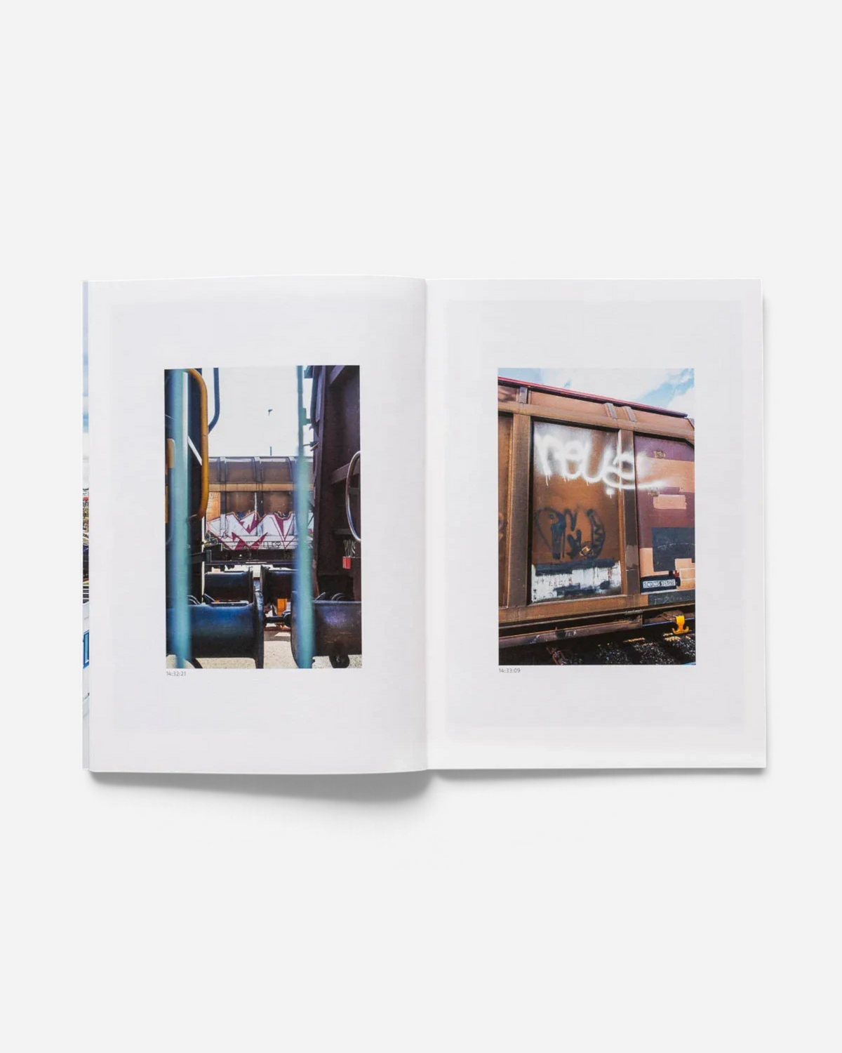Astrofat 136 Minutes of Malmö zine open to pages showing freight train graffiti photography in a rail yard