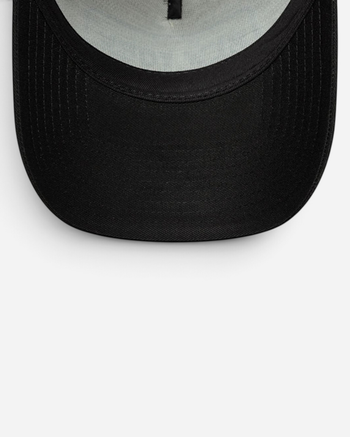 Astrofat 9FORTY trucker cap featuring a curved navy visor and a cream-colored crown with mesh back panels.