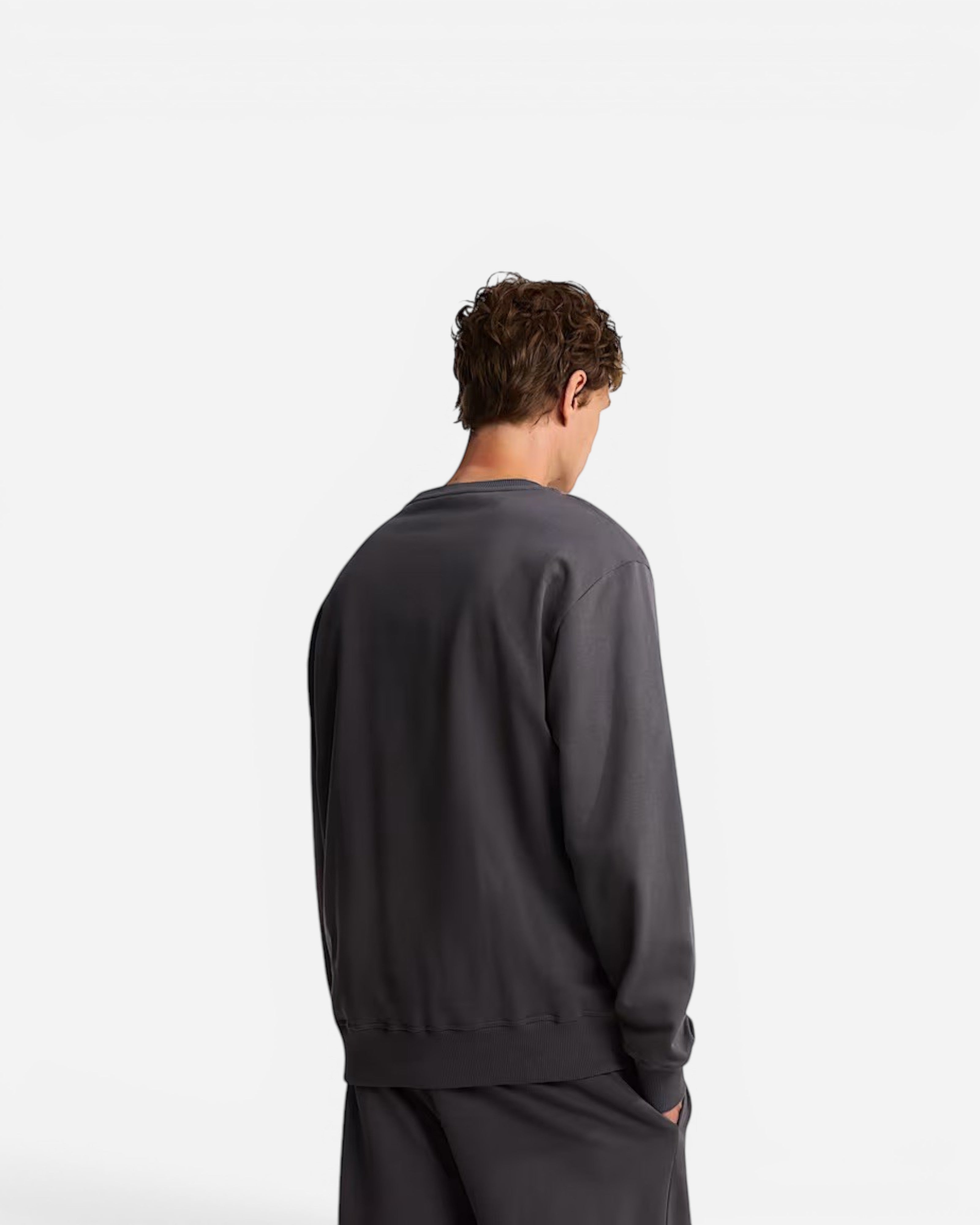 Astrofat Essential Light relaxed crewneck sweatshirt in anthracite grey worn by a man, back view.