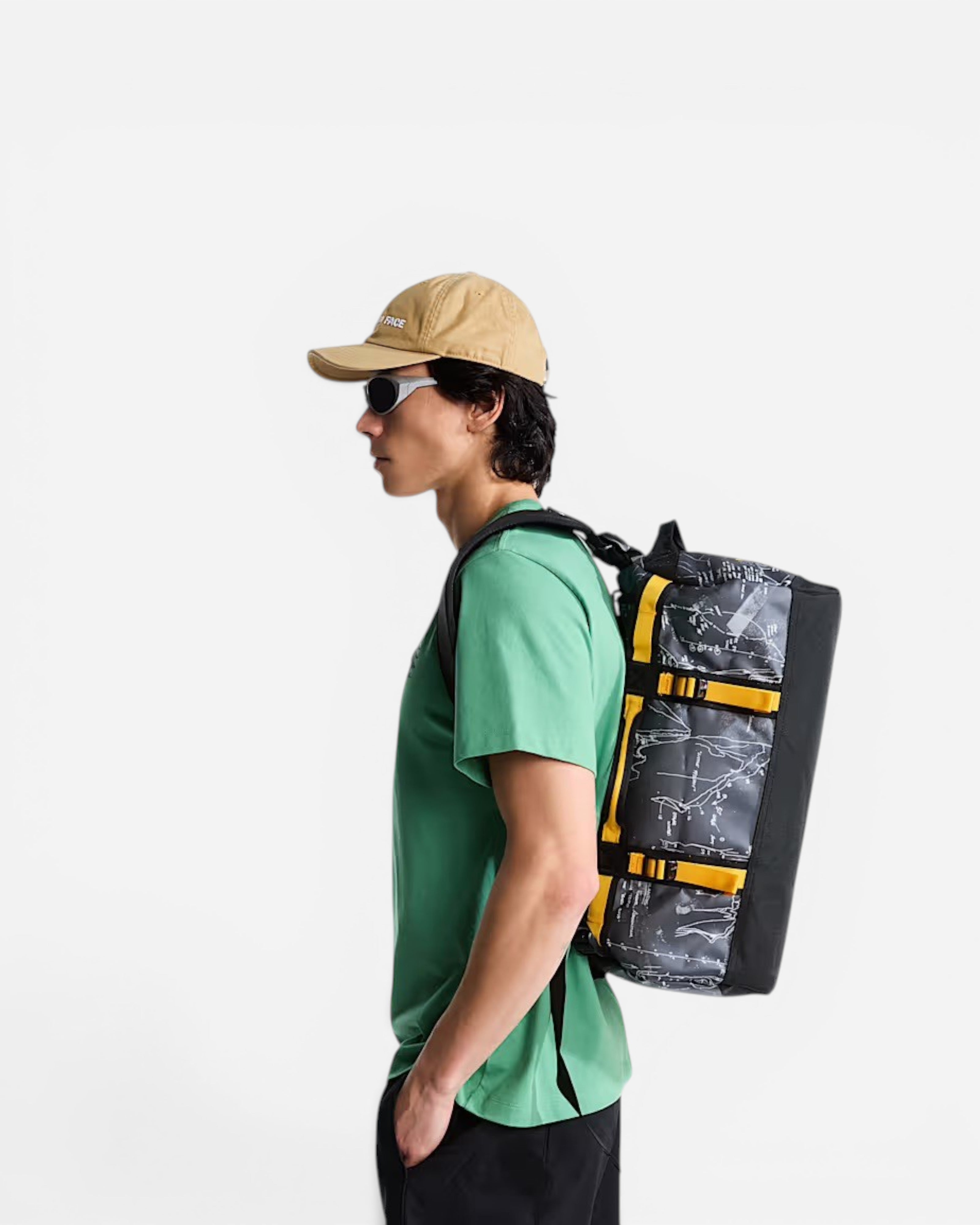 Astrofat Base Camp XS 31L duffel bag in anthracite grey topos print with summit gold straps worn as a backpack.