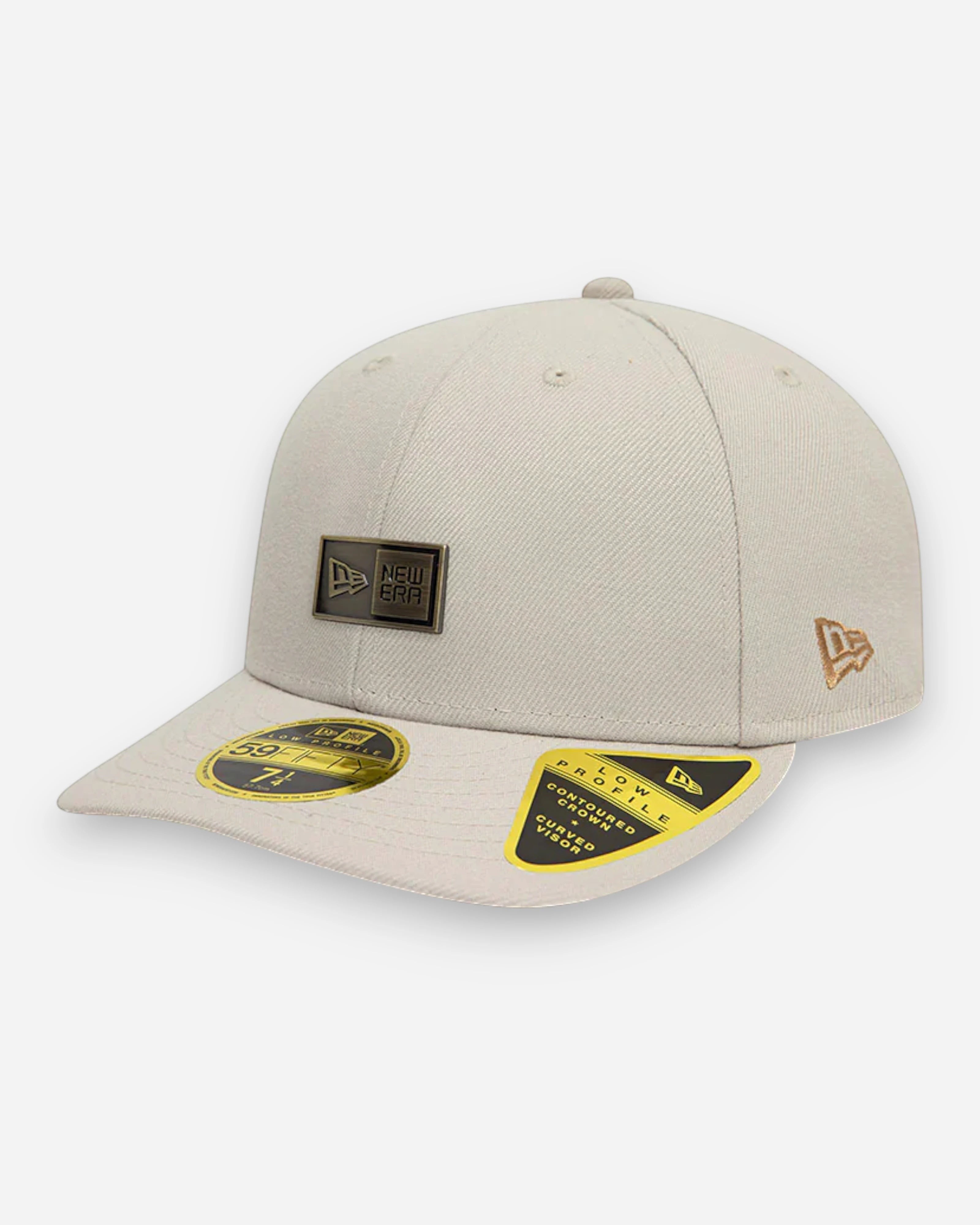 Astrofat 59FIFTY Low Profile cap in light beige with a metallic badge on the front and embroidered New Era flag on the side.