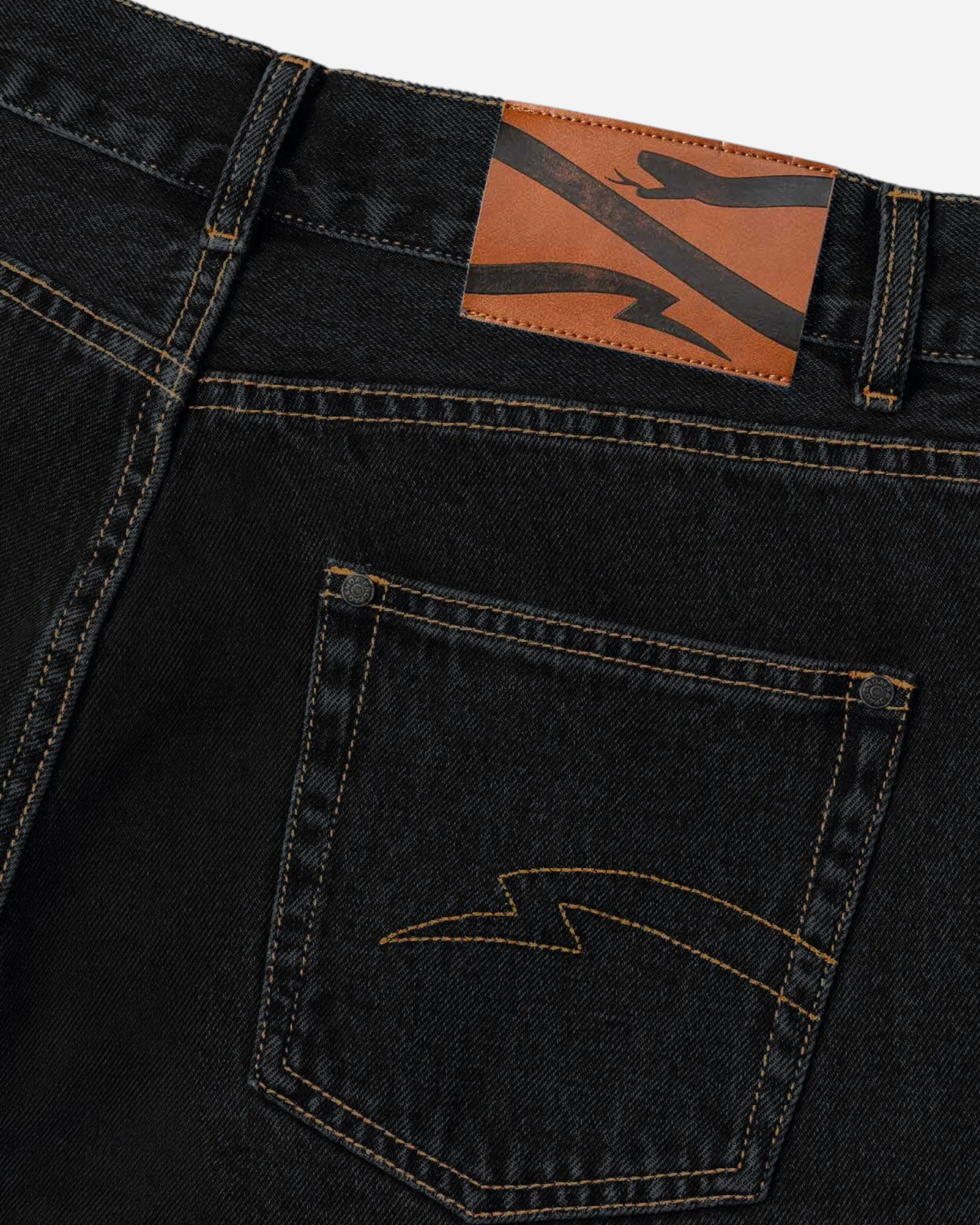 Astrofat black denim shorts featuring a brown leather brand patch and embroidered lightning bolt detail on the pocket