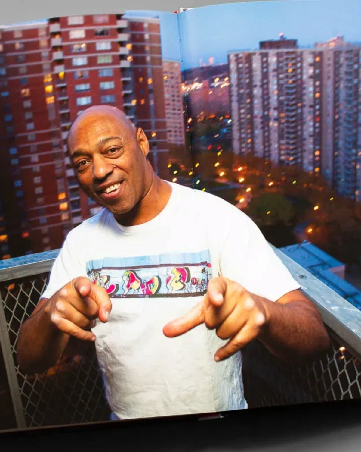 Astrofat BLADE King Of Graffiti hardcover book open to a page showing a portrait of the artist against city buildings