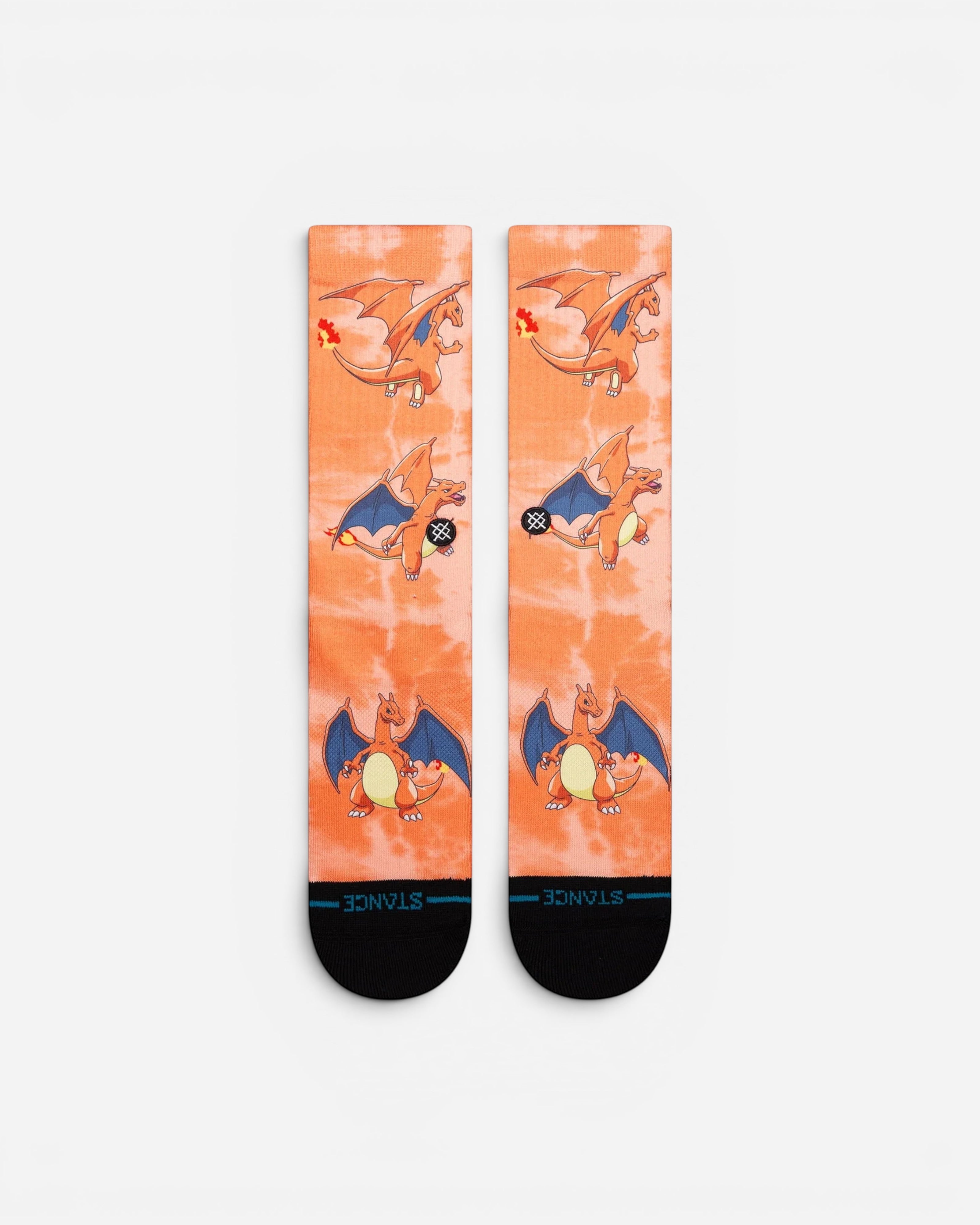 Astrofat Pokemon Charizard crew socks in orange tie-dye with all-over character print and black toe and heel details.