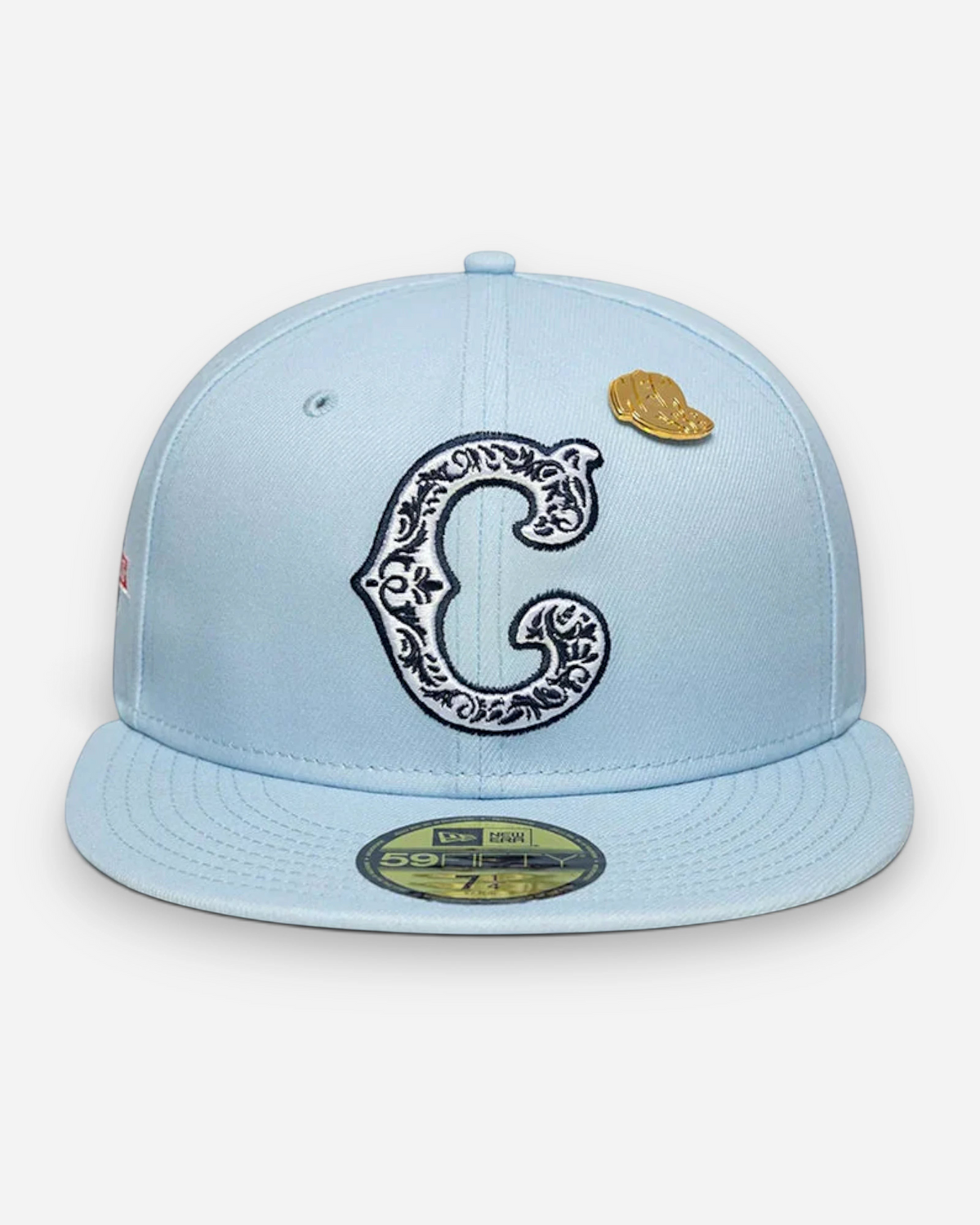 Astrofat light blue Chicago Cubs 59FIFTY fitted cap with ornate C logo, flat brim, and gold baseball cap pin.
