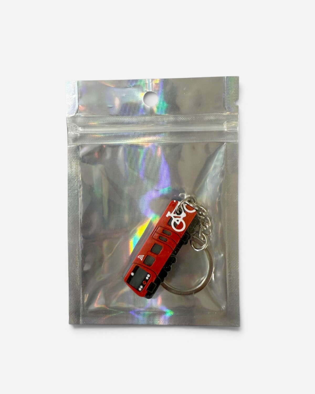 Astrofat Copenhagen S-Train keychain in red with white bicycle icon, 3D printed FDM design in a holographic bag.