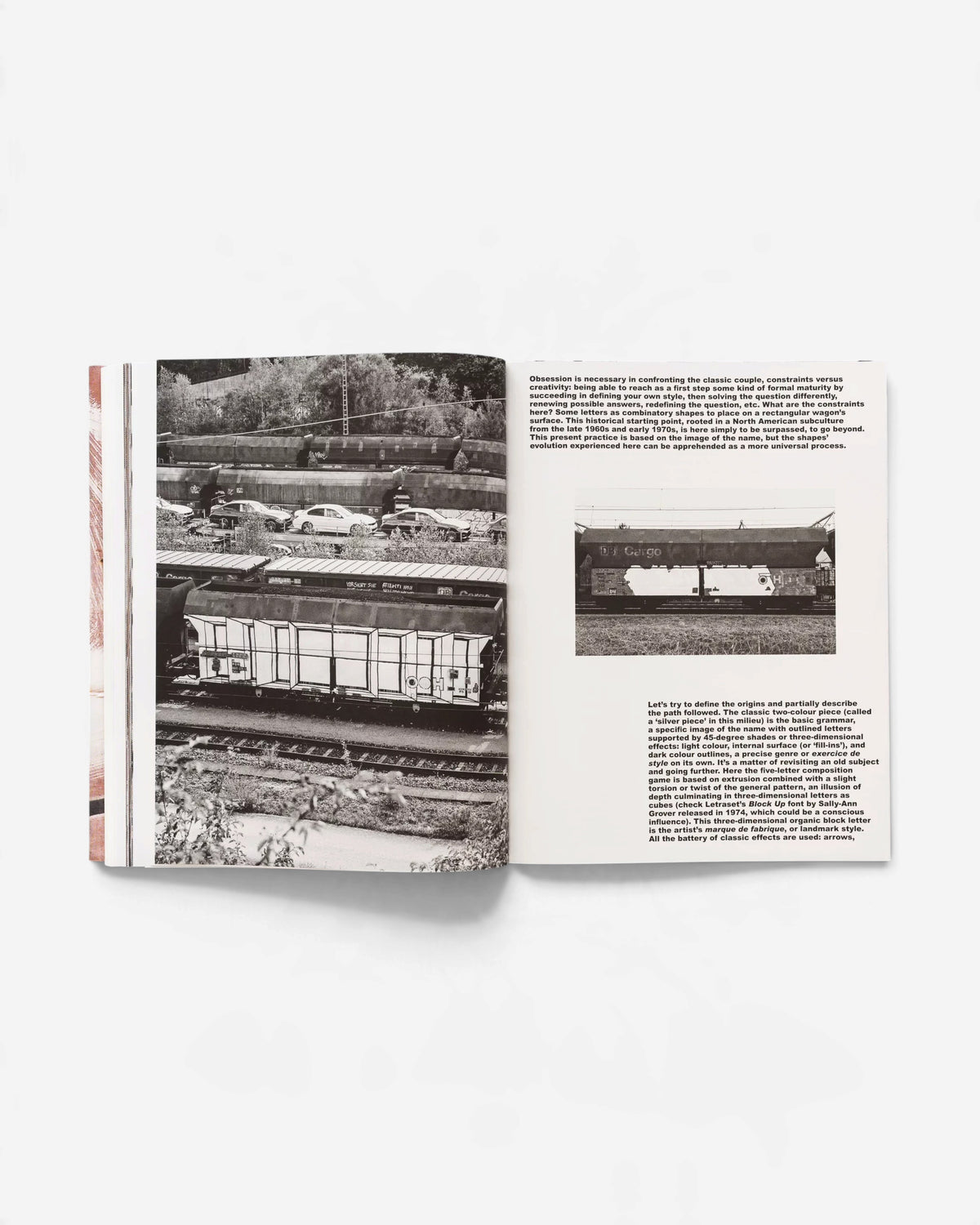 Astrofat book spread featuring black and white photographs of graffiti-painted DB cargo train wagons and descriptive text