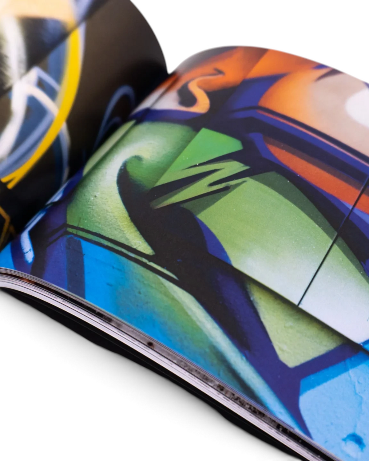 Astrofat DOES First 20 Years book open to pages featuring vibrant graffiti sketches and colorful mural artwork.