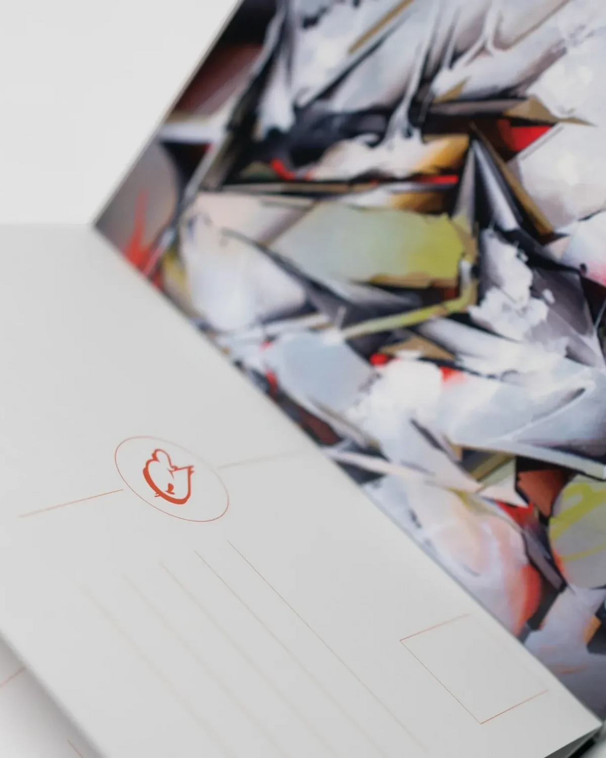 Astrofat DOES Fragments postcard set featuring a vibrant graffiti mural print and minimalist branding details.