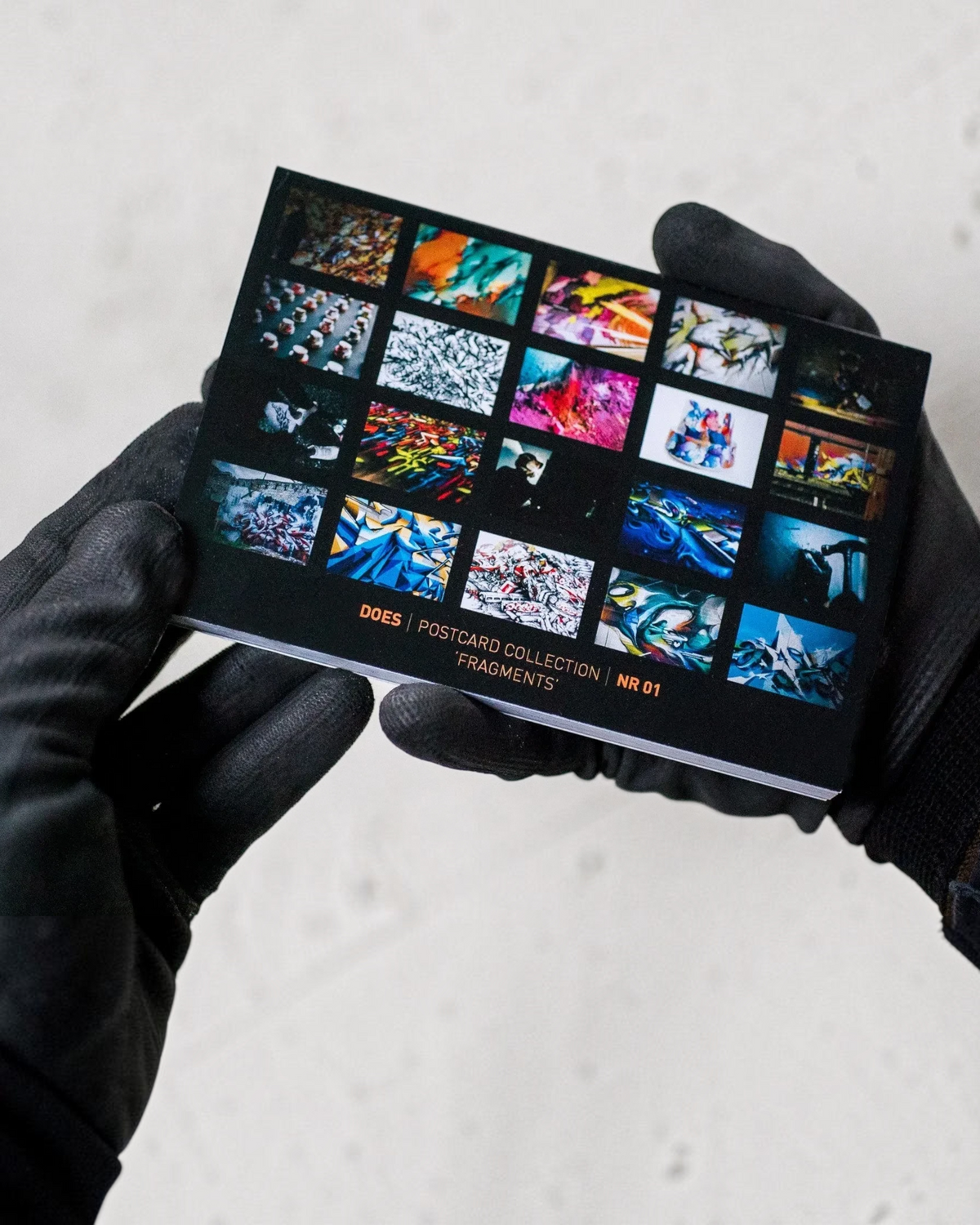 Astrofat DOES Fragments postcard set N°1 featuring a grid of colorful graffiti art images on a black background