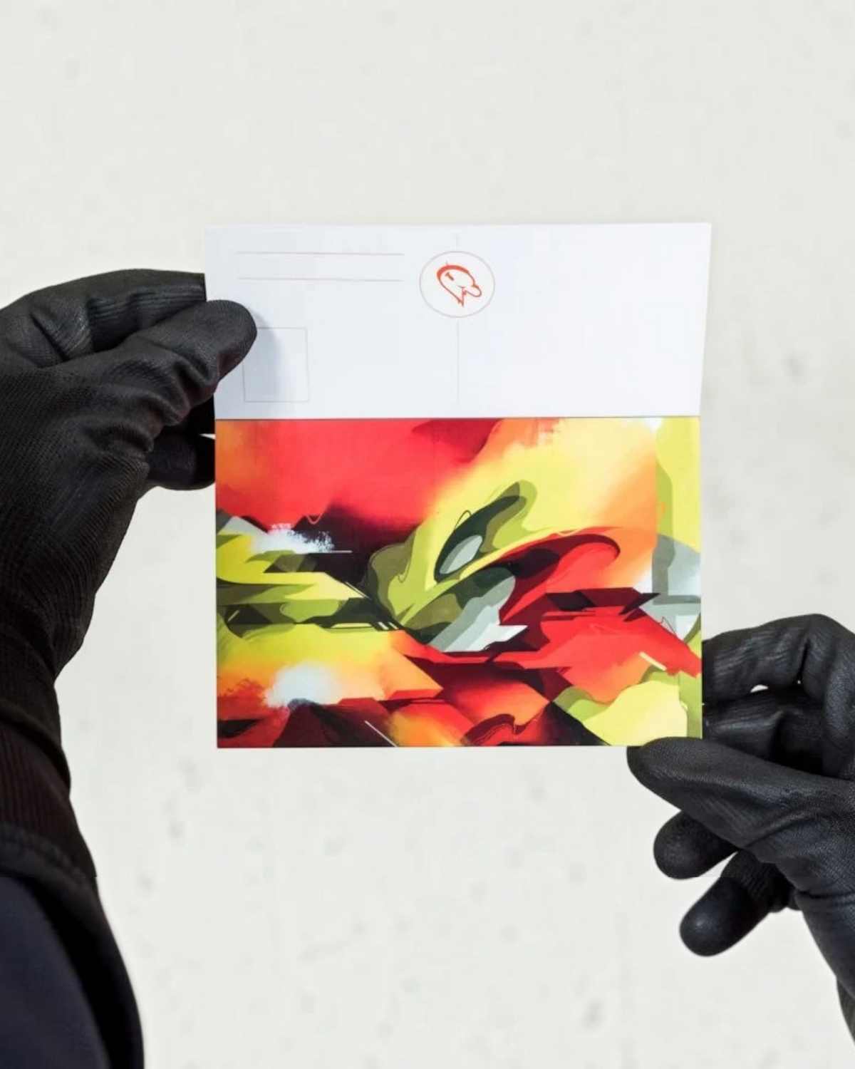 Astrofat DOES Close Up postcard set featuring vibrant abstract graffiti art held by hands in black gloves.