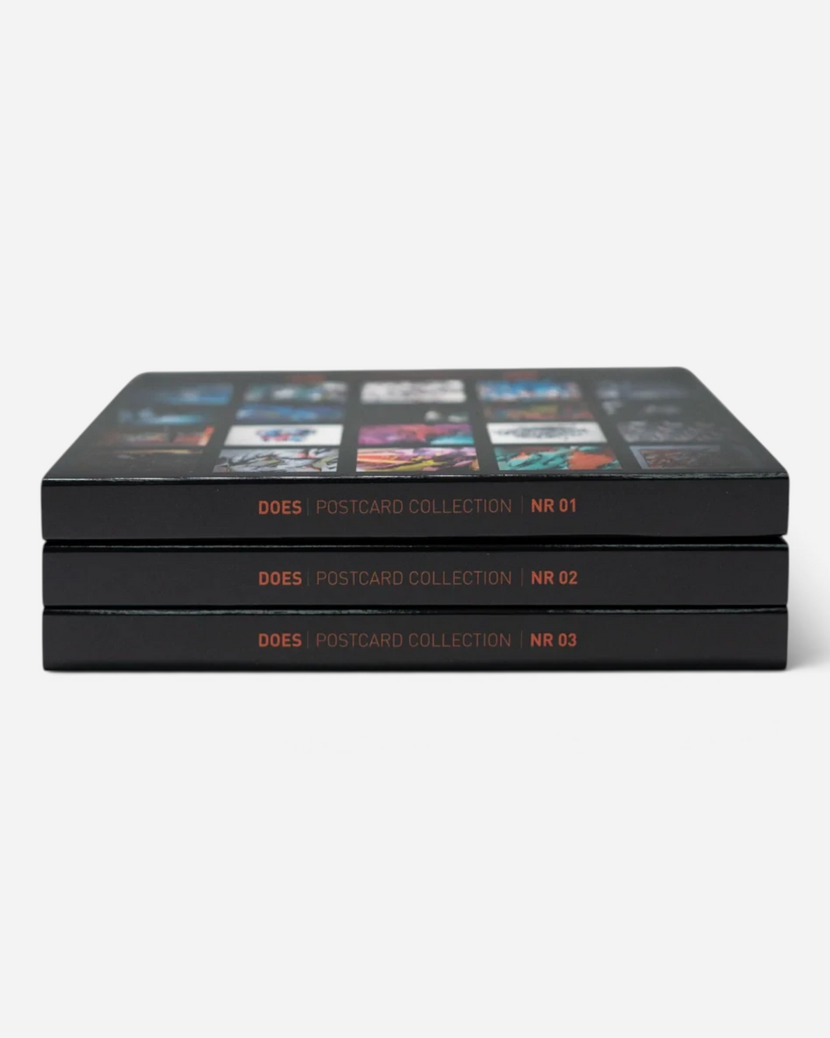 Astrofat limited edition DOES postcard set containing three stacked black booklets with numbered spines
