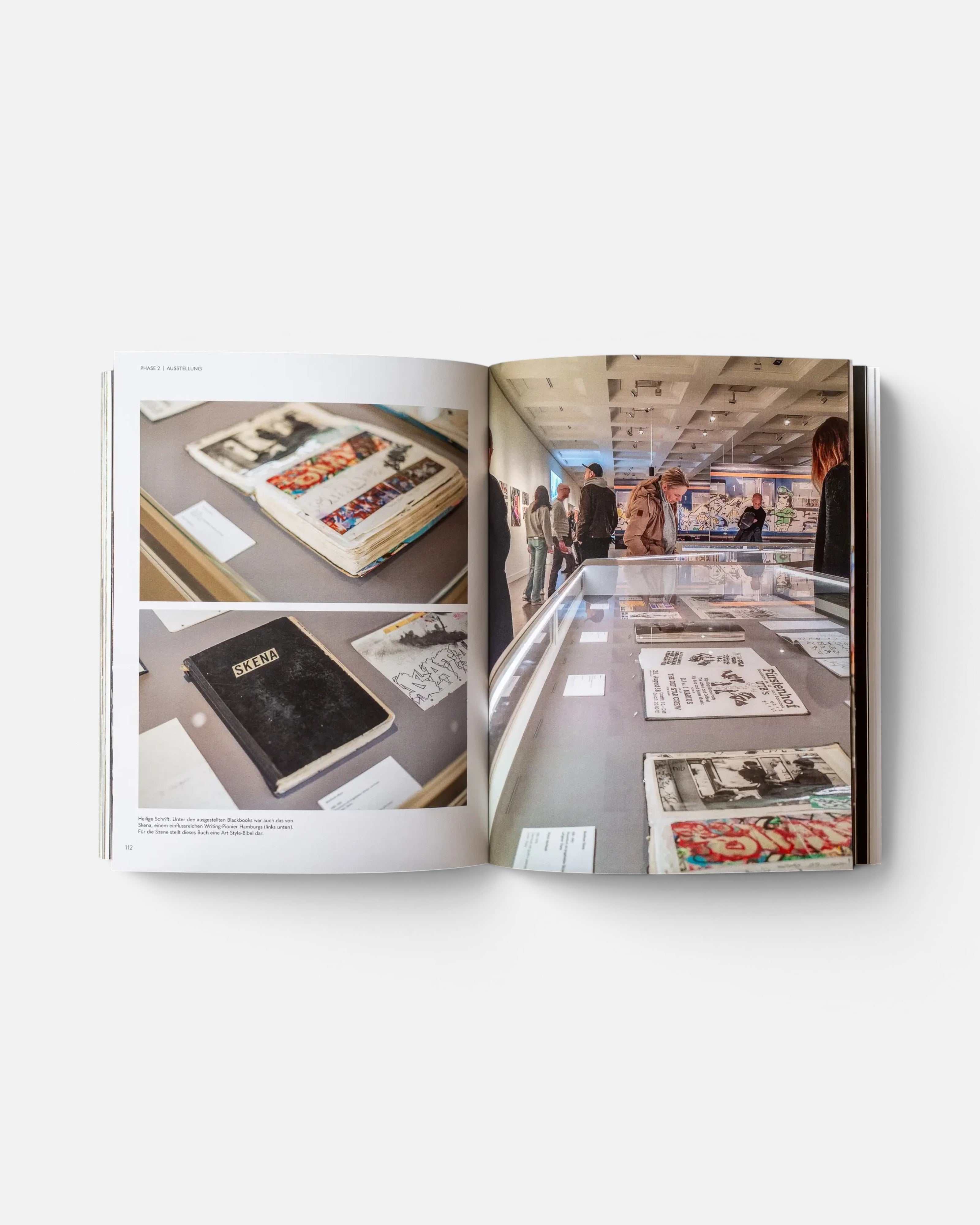 Open pages of Astrofat EINE STADT WIRD BUNT. FLASHBACK book showing graffiti exhibition photos and blackbooks.
