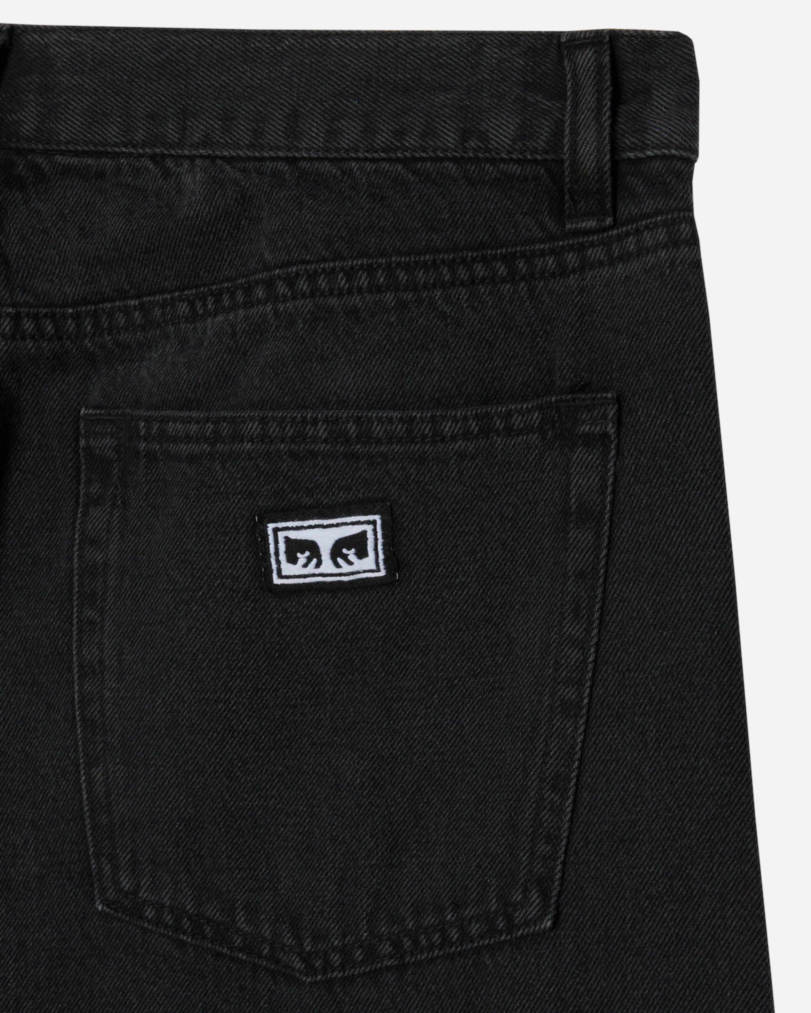 Astrofat Emerson Denim Pant in washed black, featuring a relaxed fit, 5-pocket style, and a subtle embroidered logo on the back pocket.
