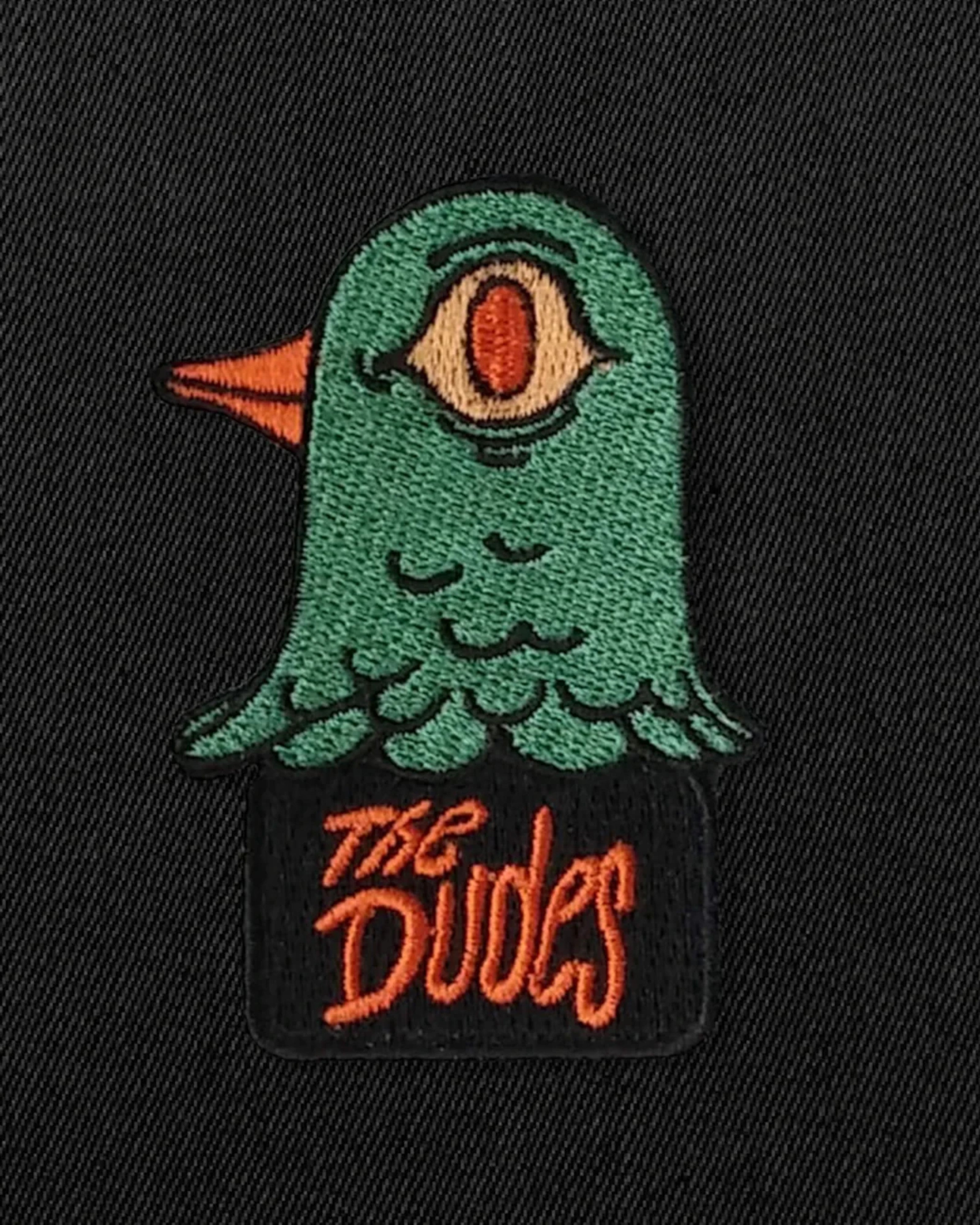 Astrofat black t-shirt with a green embroidered pigeon graphic with one eye and orange beak, text reads "The Dudes".
