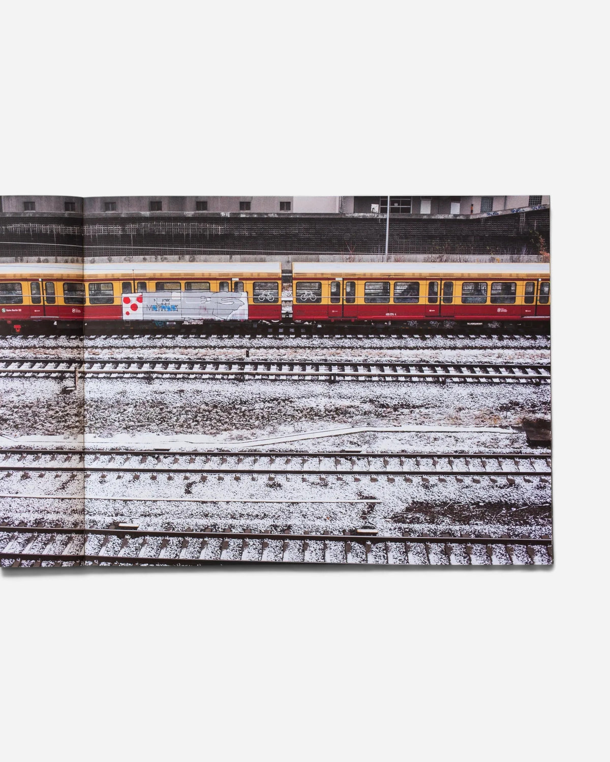 A spread from the Astrofat Farbzüge book showing a graffiti-covered Berlin S-Bahn train on snowy tracks.