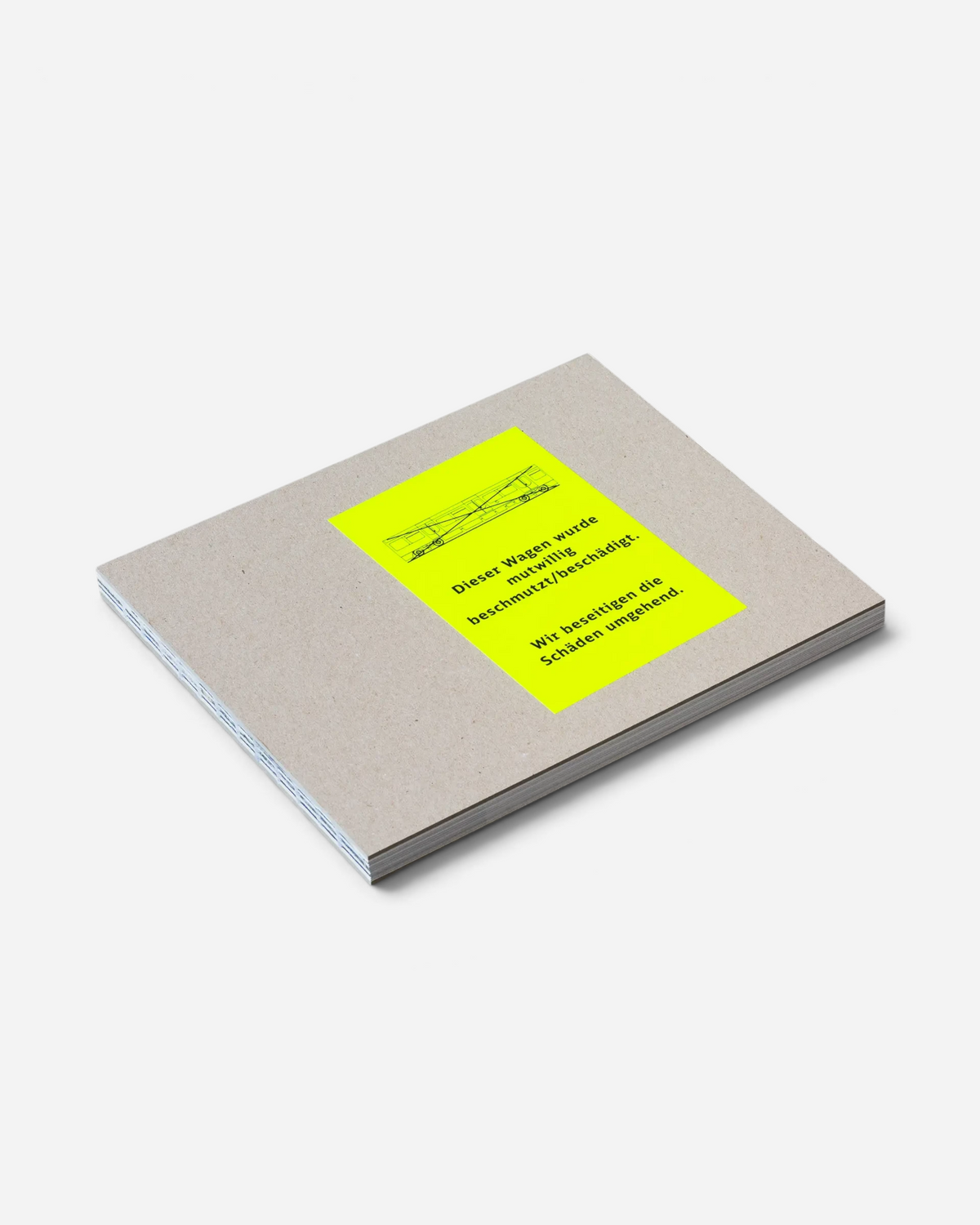 Astrofat Farbzüge hardcover photography book with raw cardboard cover and neon yellow warning sticker on grey background