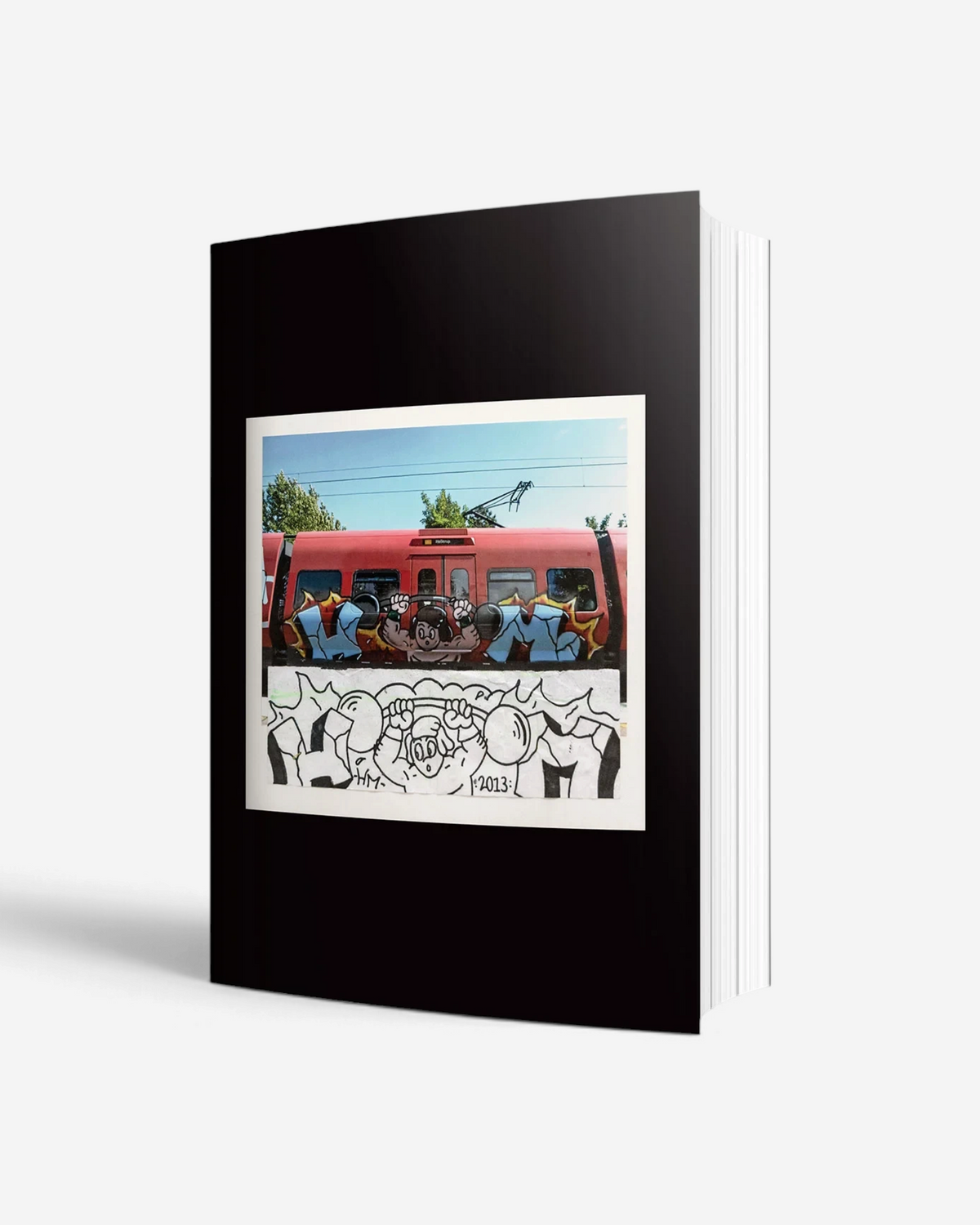 Astrofat From Sketch To Piece hardcover graffiti book showing a train mural and its original sketch on the cover