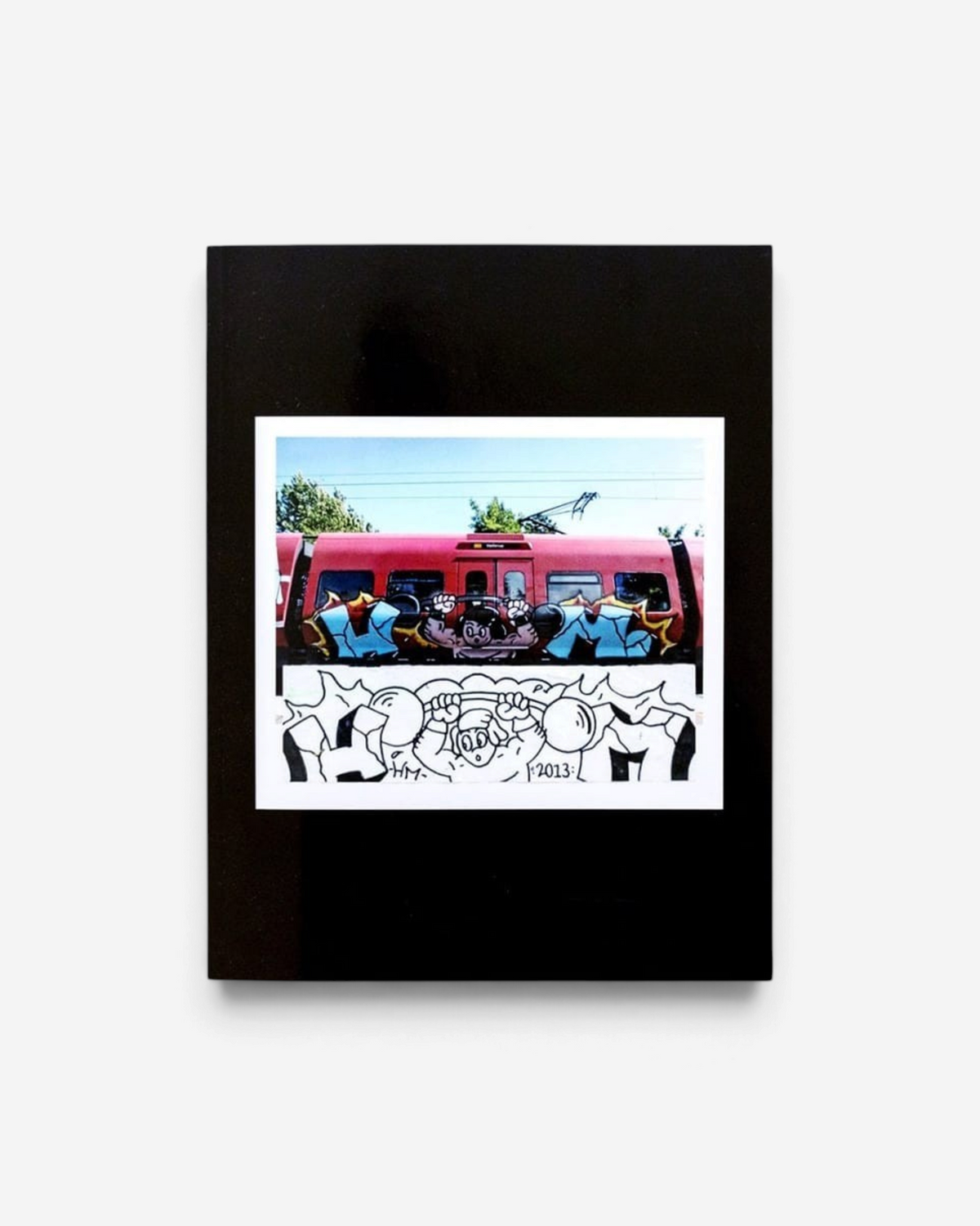 Astrofat From Sketch To Piece graffiti book featuring a side-by-side comparison of a sketch and a painted train car.