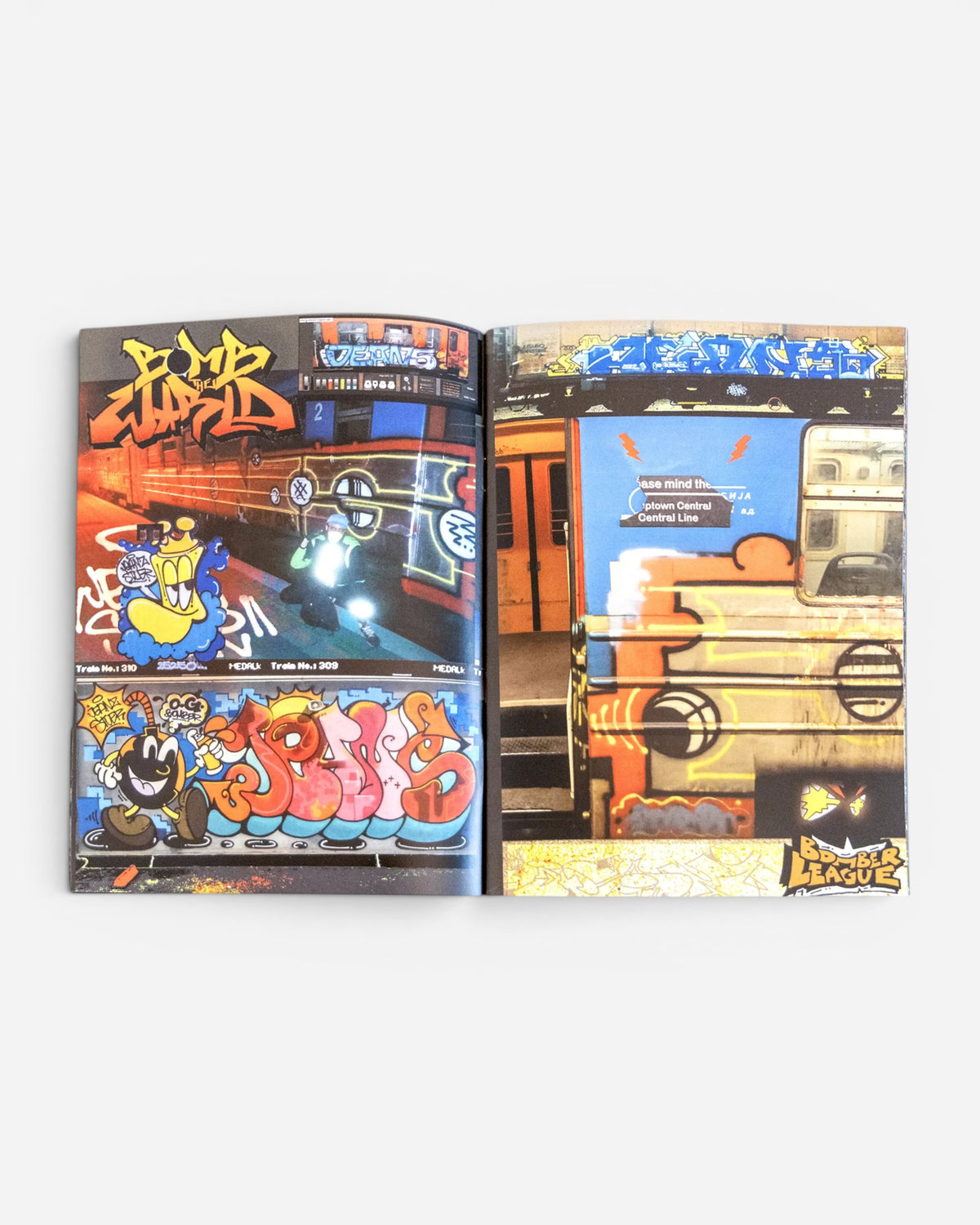 Astrofat Ghetto Fever Bomber League graffiti zine open to pages showing vibrant train art and character illustrations.