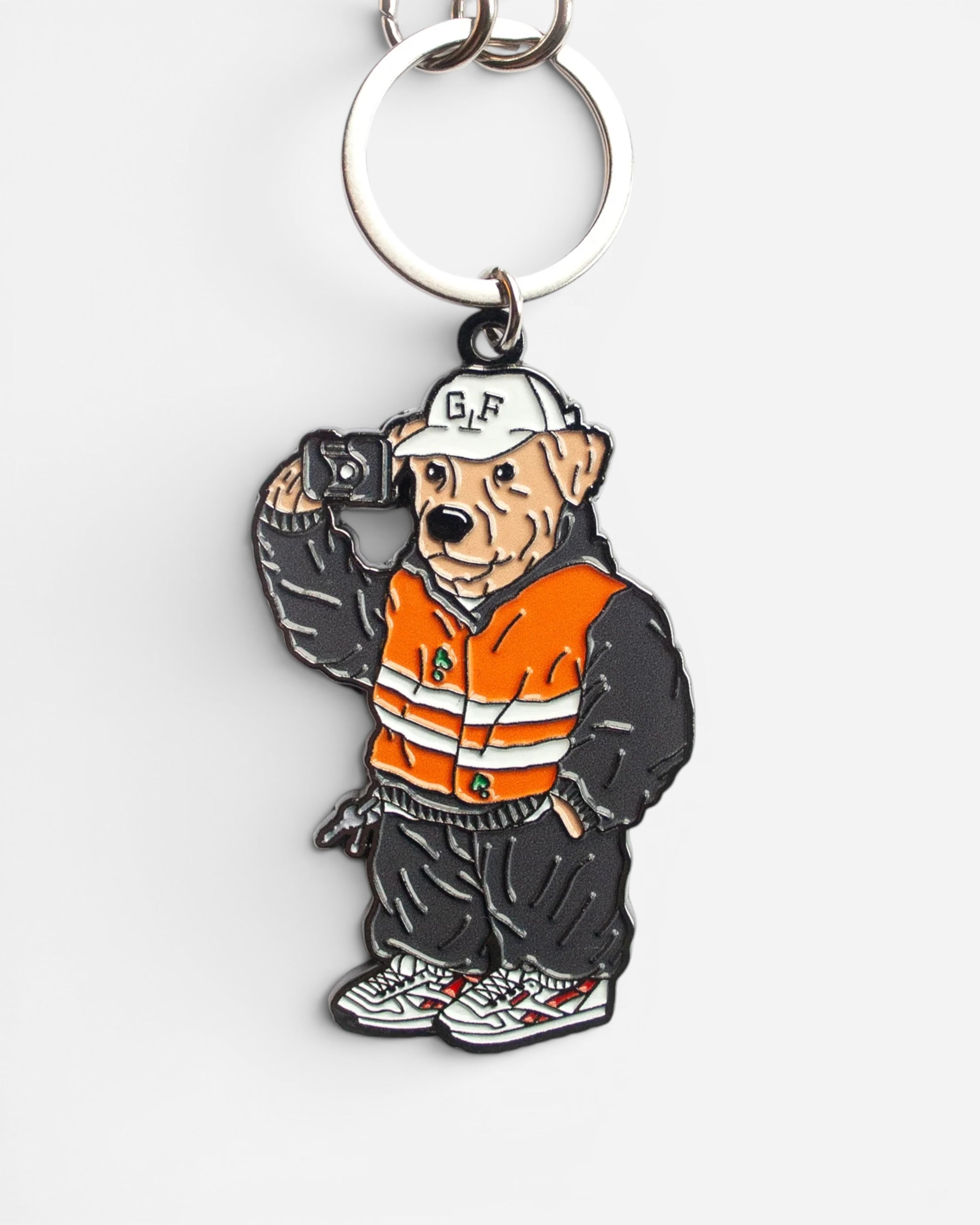 Astrofat Ghetto Fever Underdog rubber keychain featuring a dog in an orange vest and cap with a metal ring
