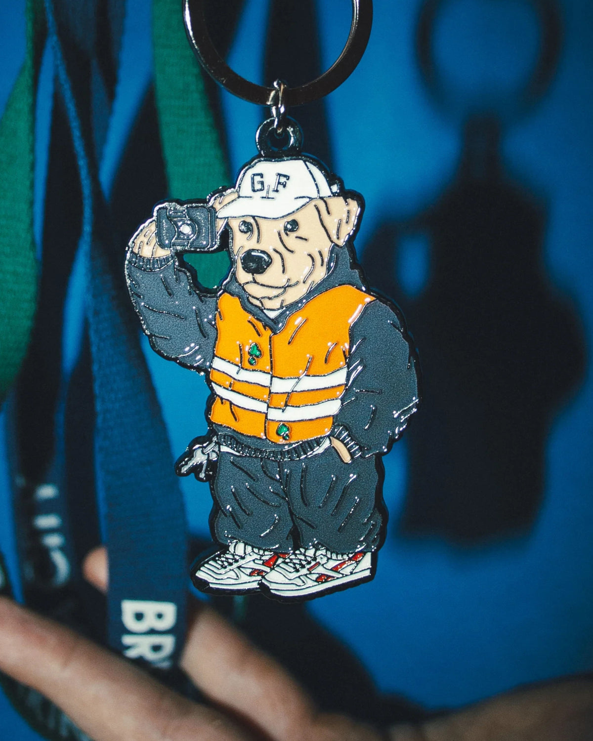 Astrofat Ghetto Fever Underdog rubber keychain featuring a dog in a high-visibility vest and cap with metal ring