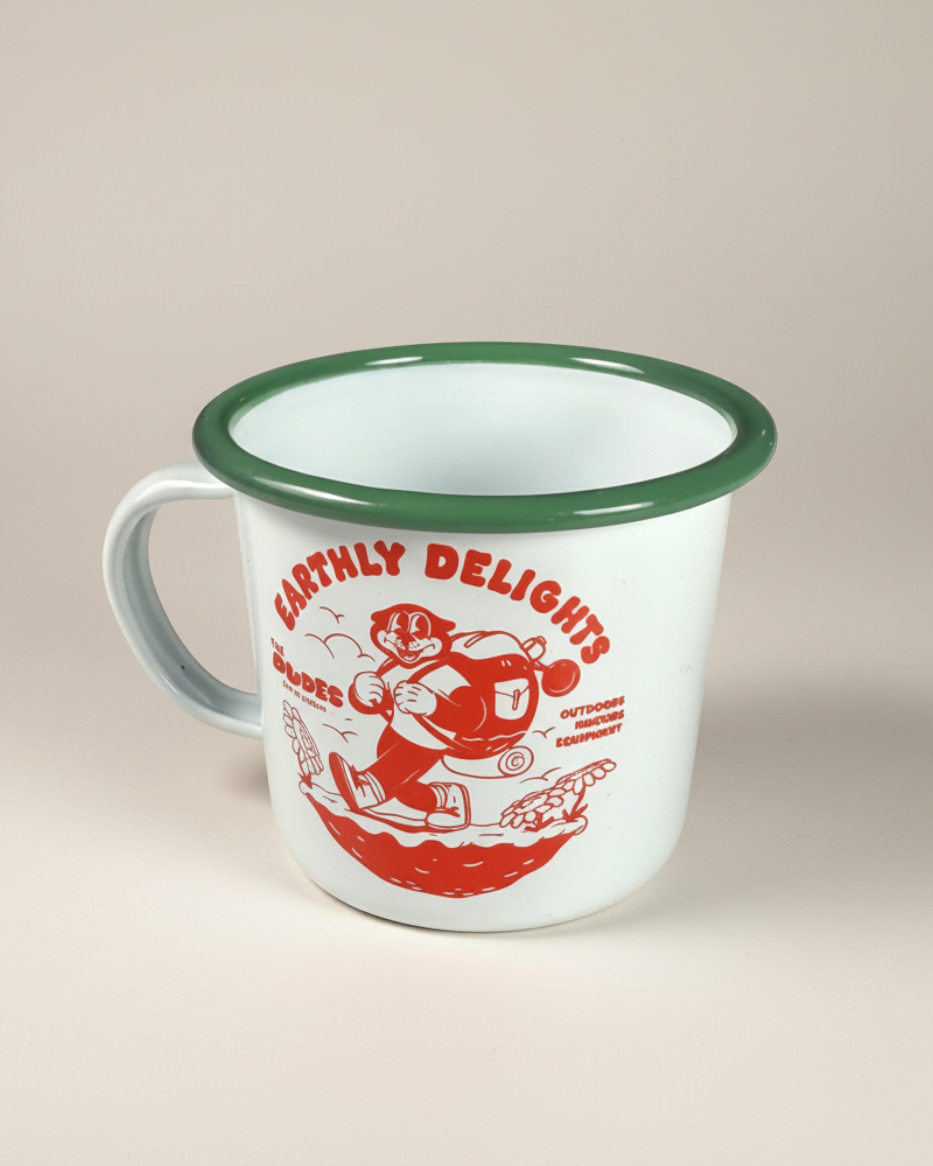 Astrofat ivory enamel mug with green rim, featuring a red "Earthly Delights" illustration by McBess.