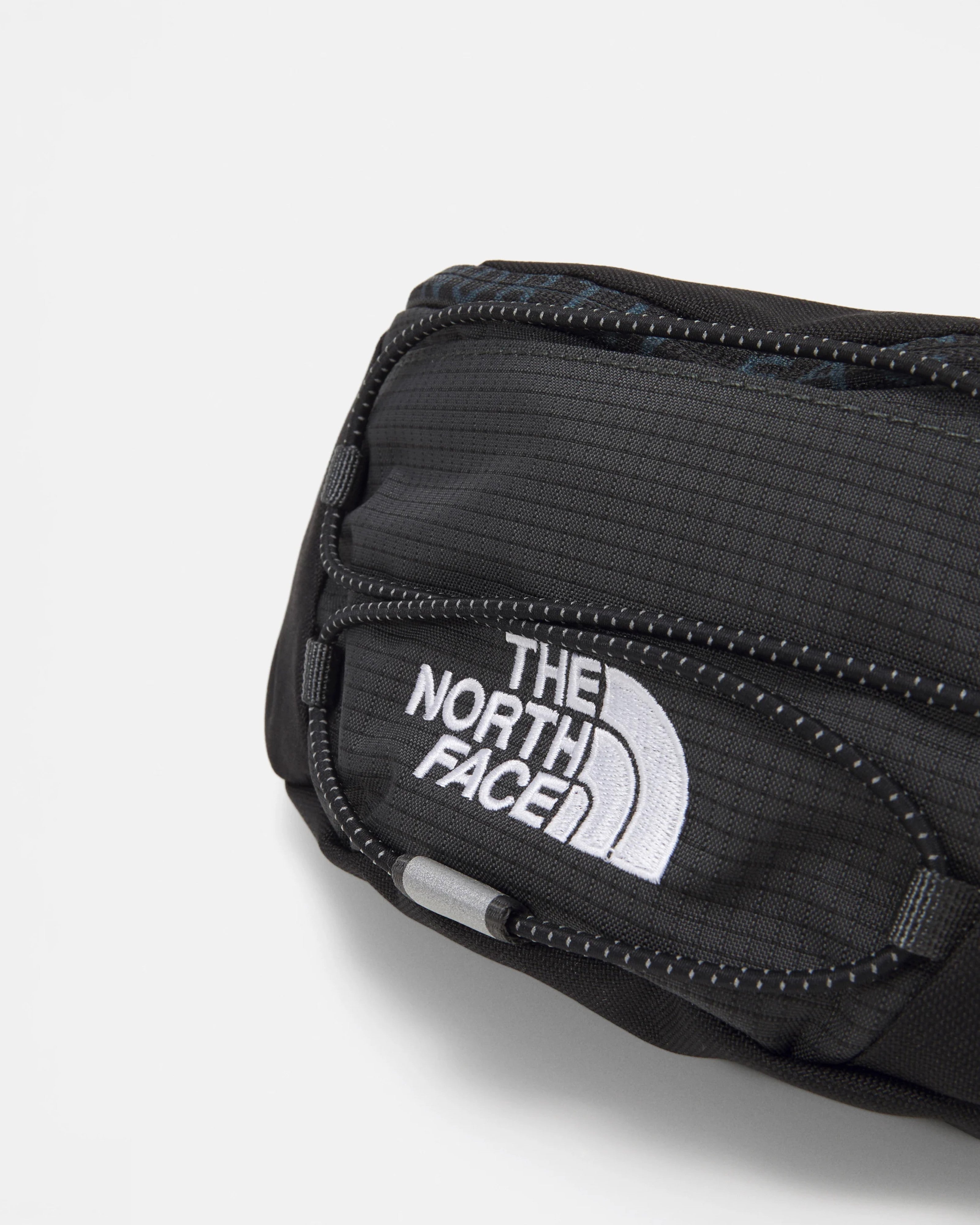 Astrofat Jester Lumbar bag in asphalt grey and TNF black, made from durable Base Camp material with adjustable strap and multiple compartments.