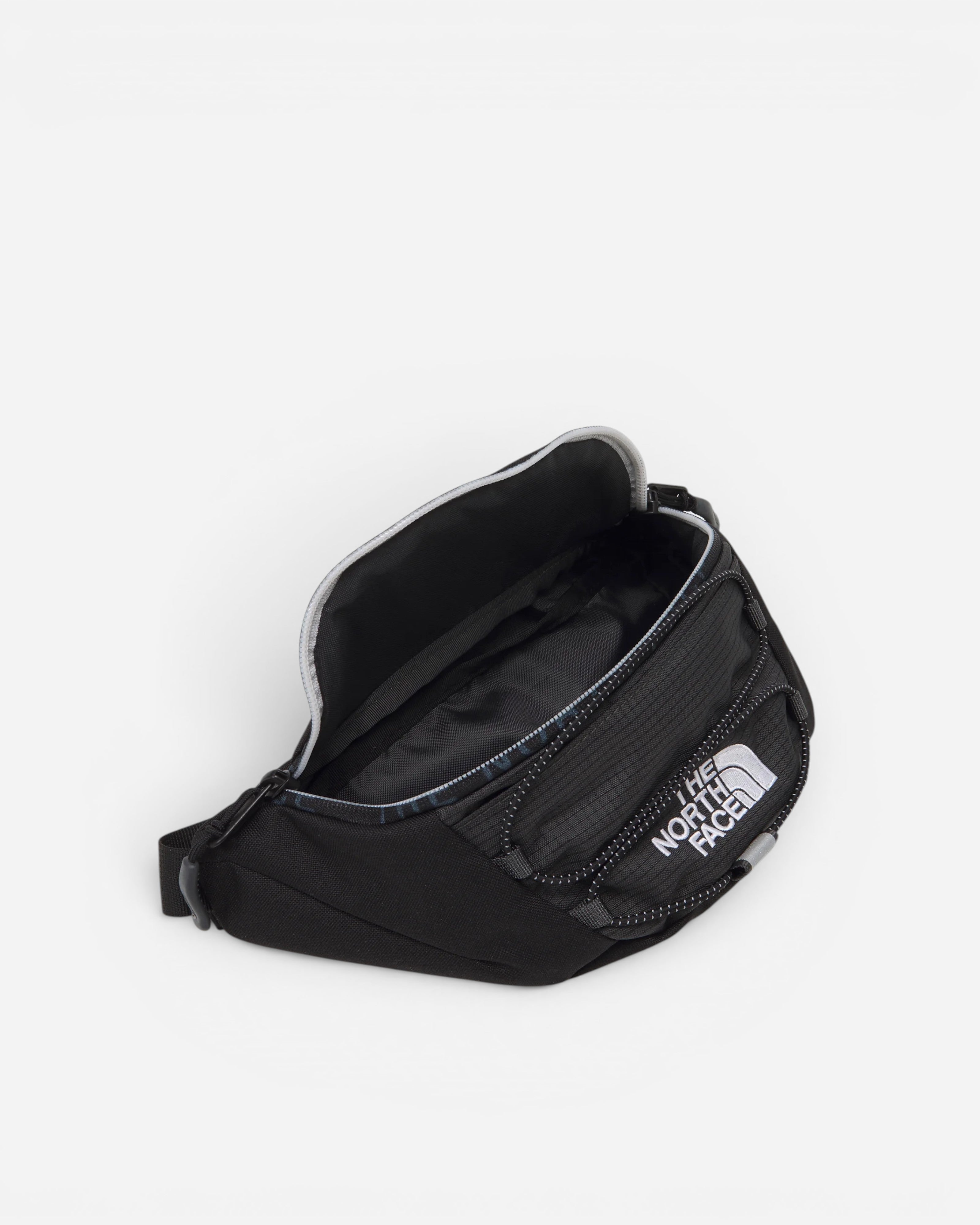 Astrofat Jester Lumbar Asphalt Grey fanny pack with black accents and The North Face logo. Features a main compartment and zippered pockets.
