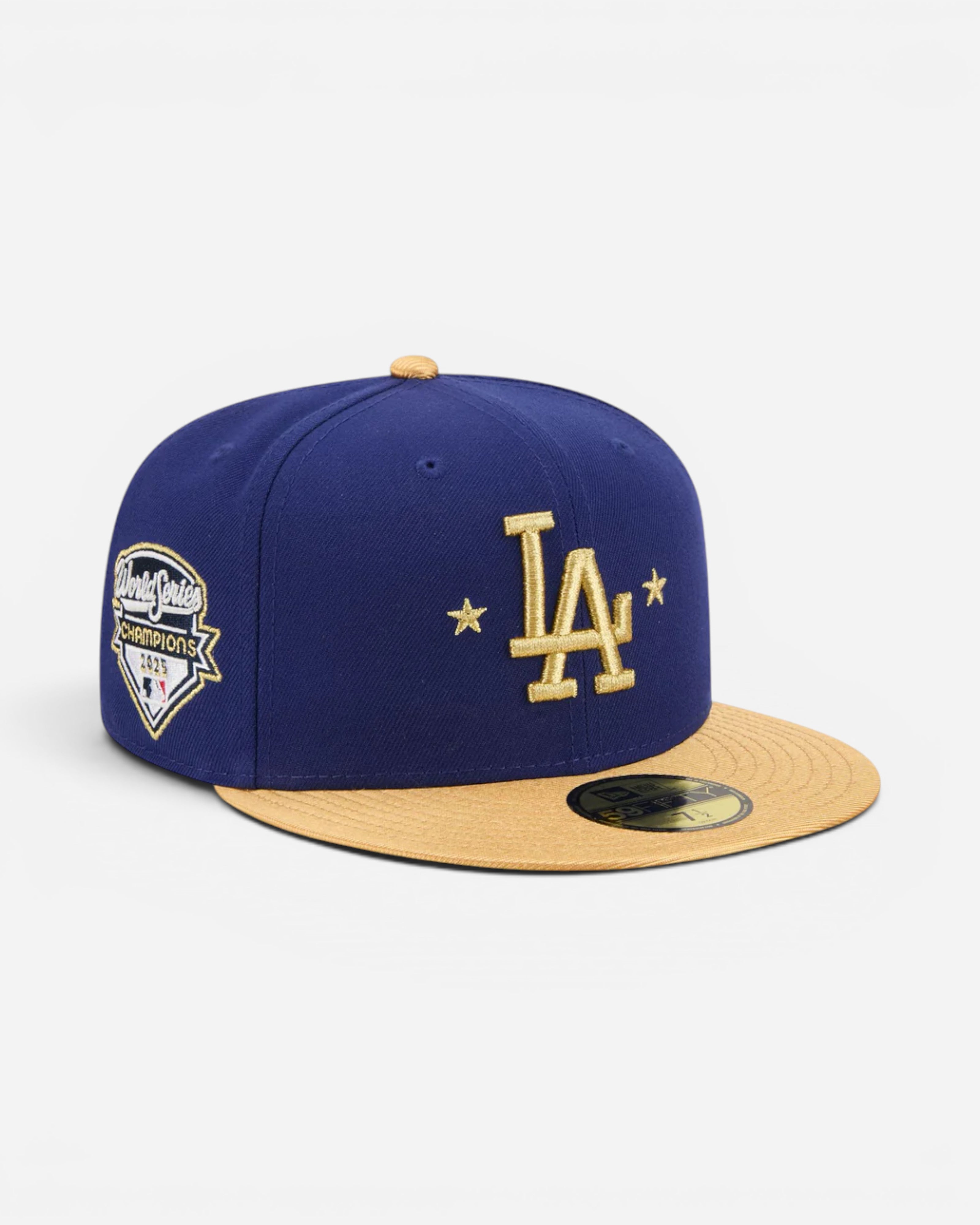 Astrofat dark blue fitted baseball cap with gold LA Dodgers logo and World Series Champions 2025 patch.