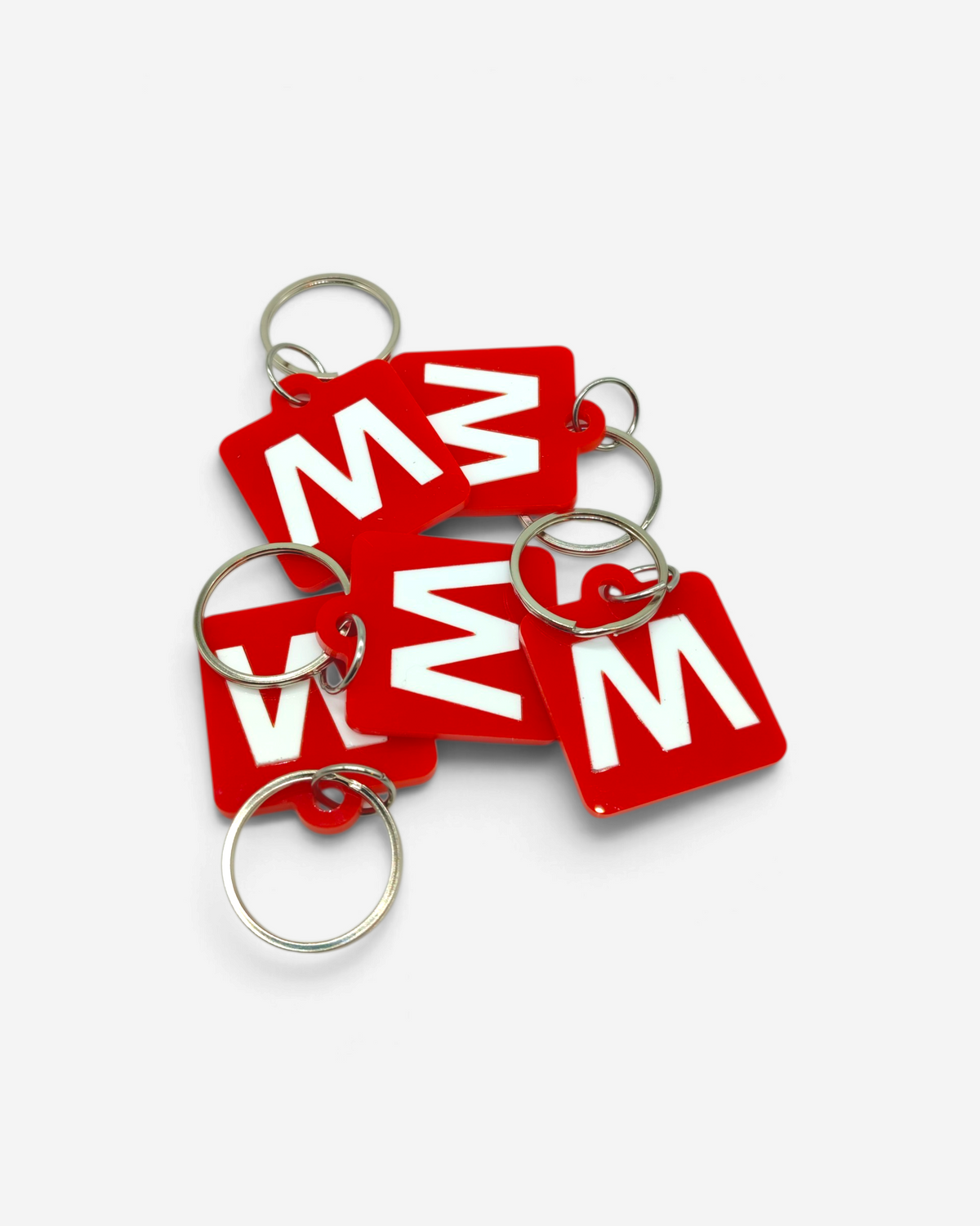 Astrofat Milano Subway rubber keychains with white M logo on red square background and silver metal rings