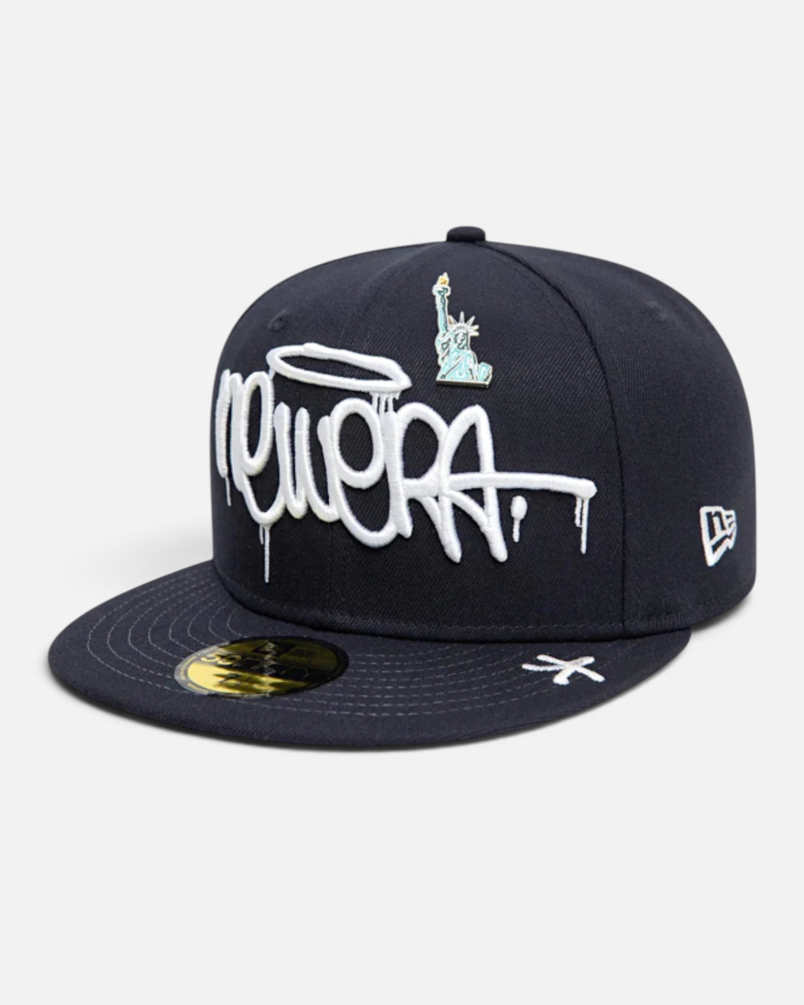 Astrofat navy 59FIFTY New Era fitted cap featuring white graffiti tag embroidery and a Statue of Liberty detail.
