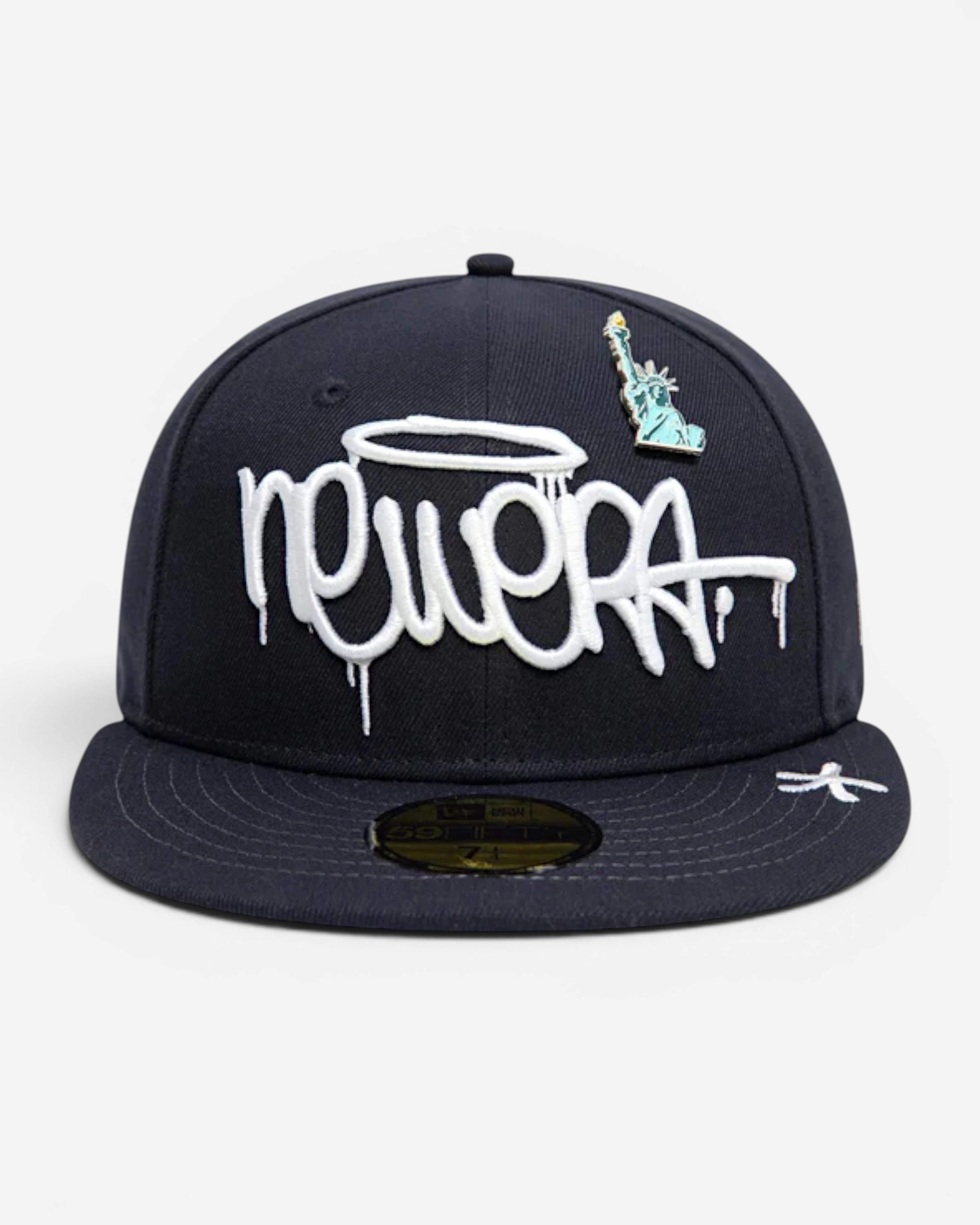 Astrofat navy 59FIFTY New Era cap featuring white graffiti-style embroidery and a Statue of Liberty pin.