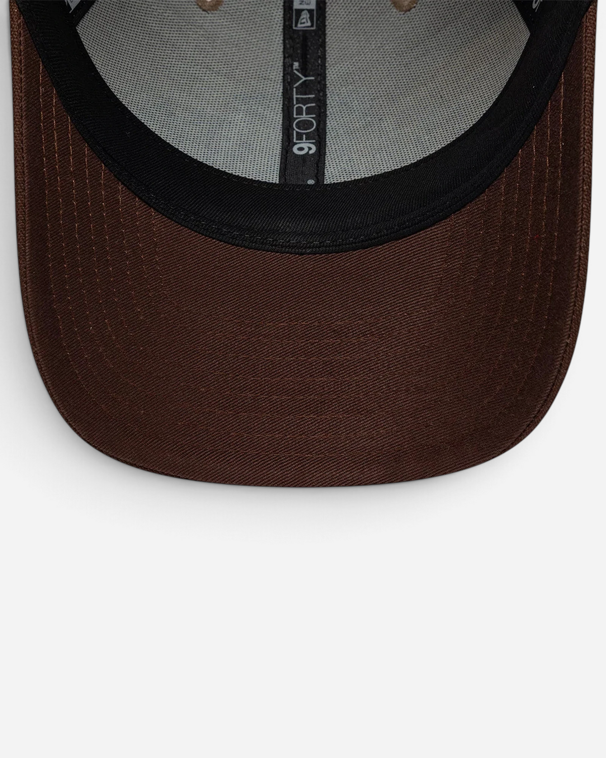 Astrofat New Era 9FORTY cap featuring a curved brown visor and structured beige crown with interior branding.