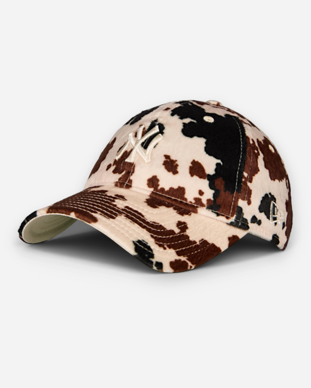 Astrofat 9FORTY New York Yankees cap featuring a brown and white cow print pattern with a curved visor and strapback.