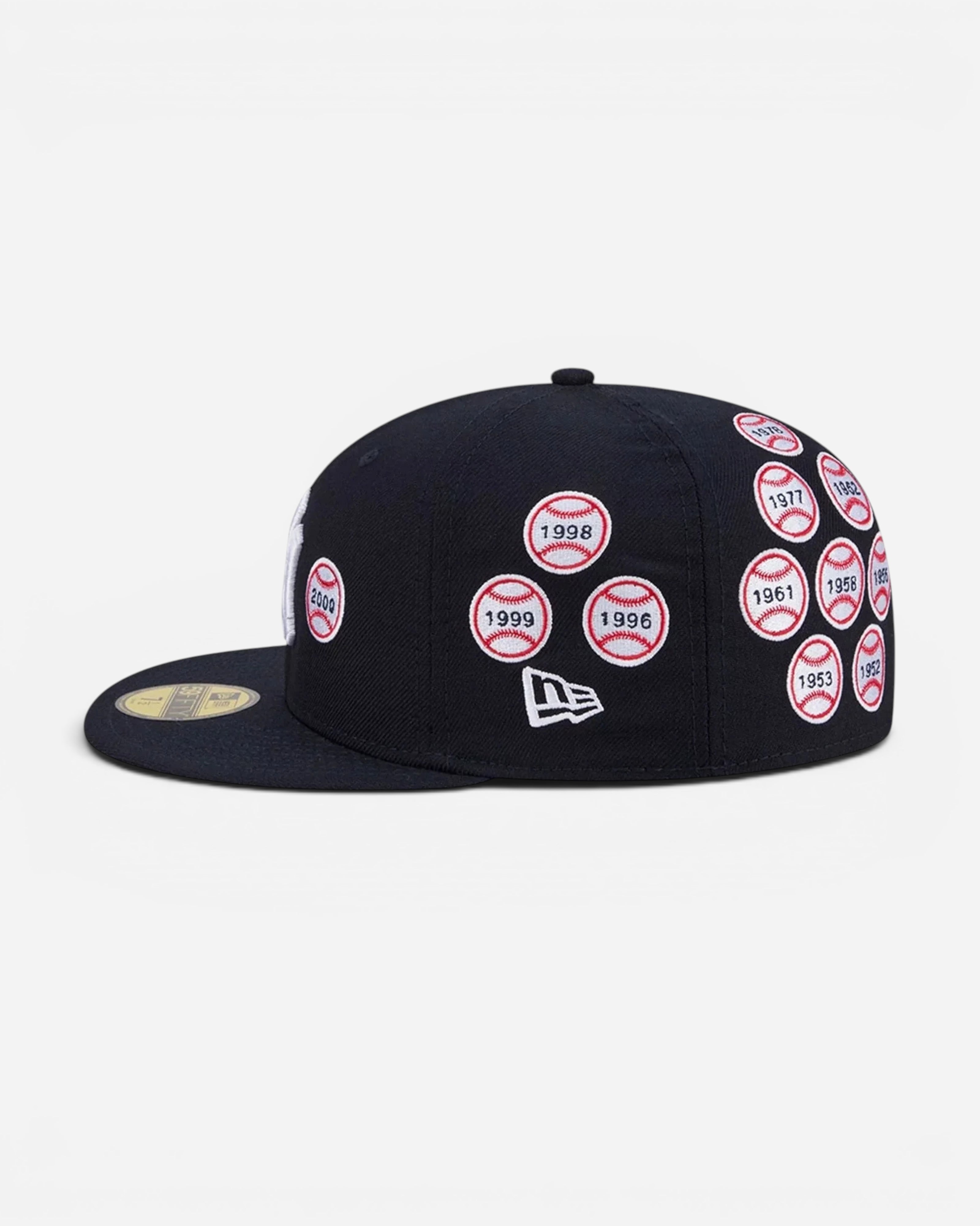 Astrofat navy blue 59FIFTY New York Yankees fitted cap featuring embroidered World Series patches on the side.