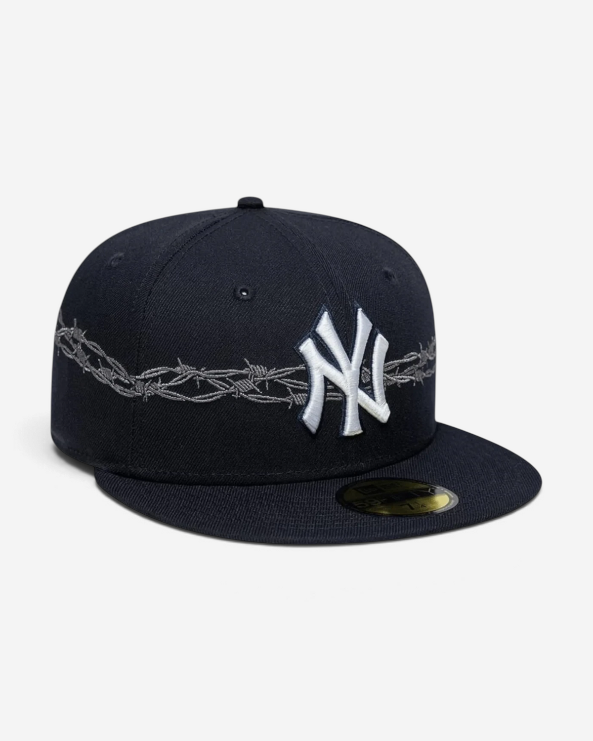 Astrofat navy blue New Era 59FIFTY fitted cap with white New York Yankees logo and grey barbed wire embroidery detail.
