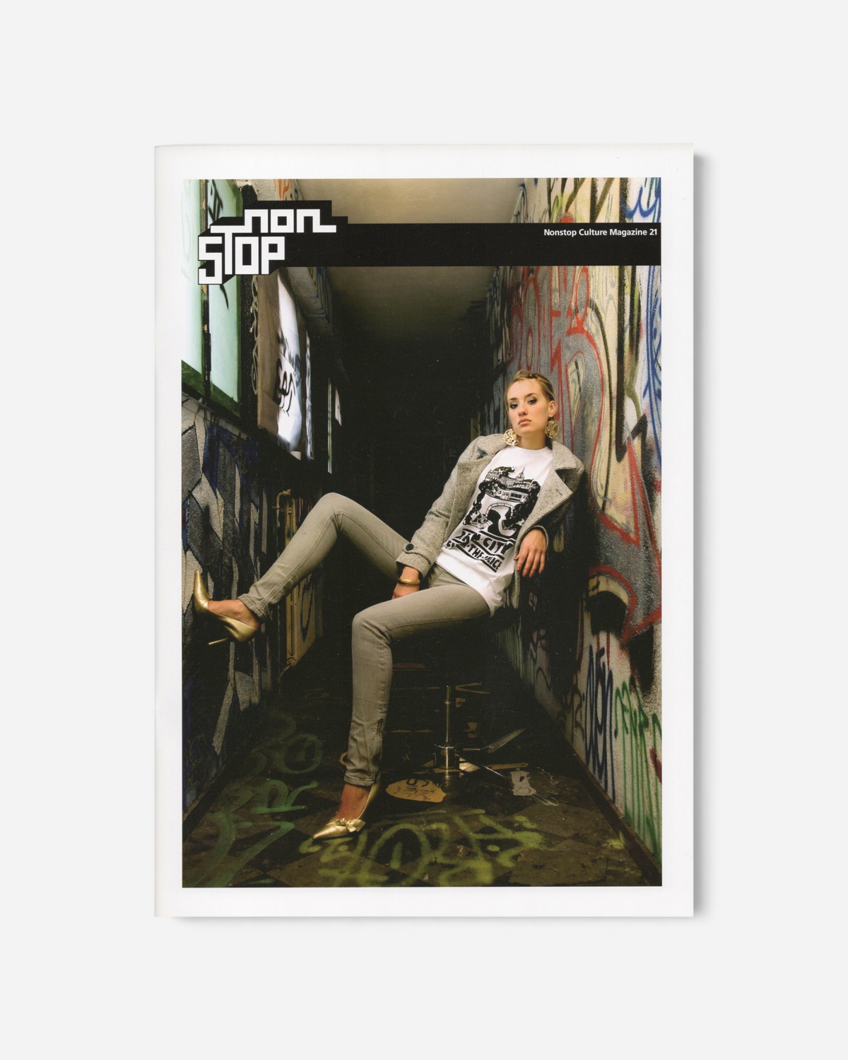 Astrofat Non Stop Magazine Issue 21 featuring a woman in a graffiti-covered corridor on the cover