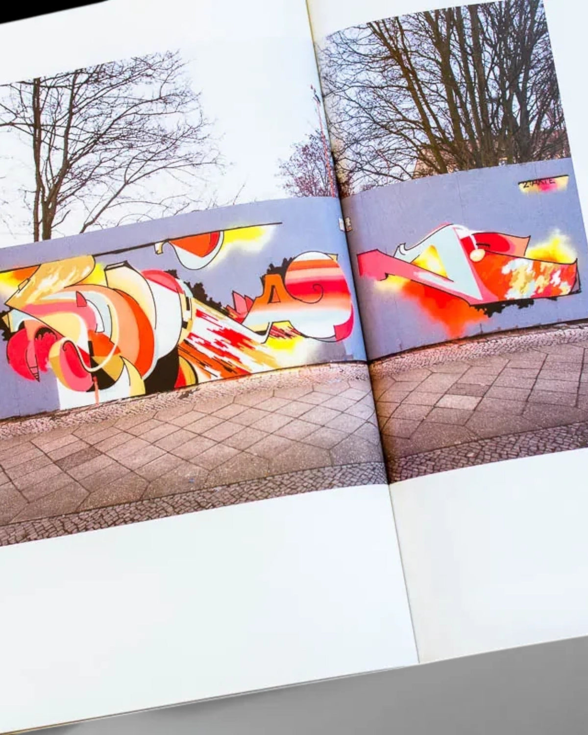 Astrofat Nonstop Magazine issue 27 open spread featuring colorful Swiss graffiti art on walls and trains