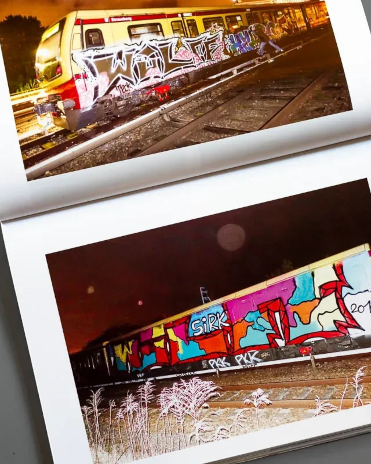 Astrofat Nonstop Magazine issue 27 open to pages showing colorful graffiti art on Swiss trains at night