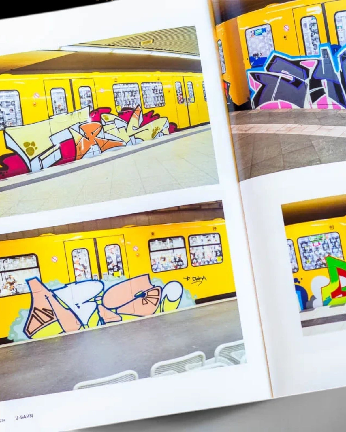 Astrofat Nonstop Magazine issue 27 open to pages showing colorful graffiti art on yellow Swiss subway trains