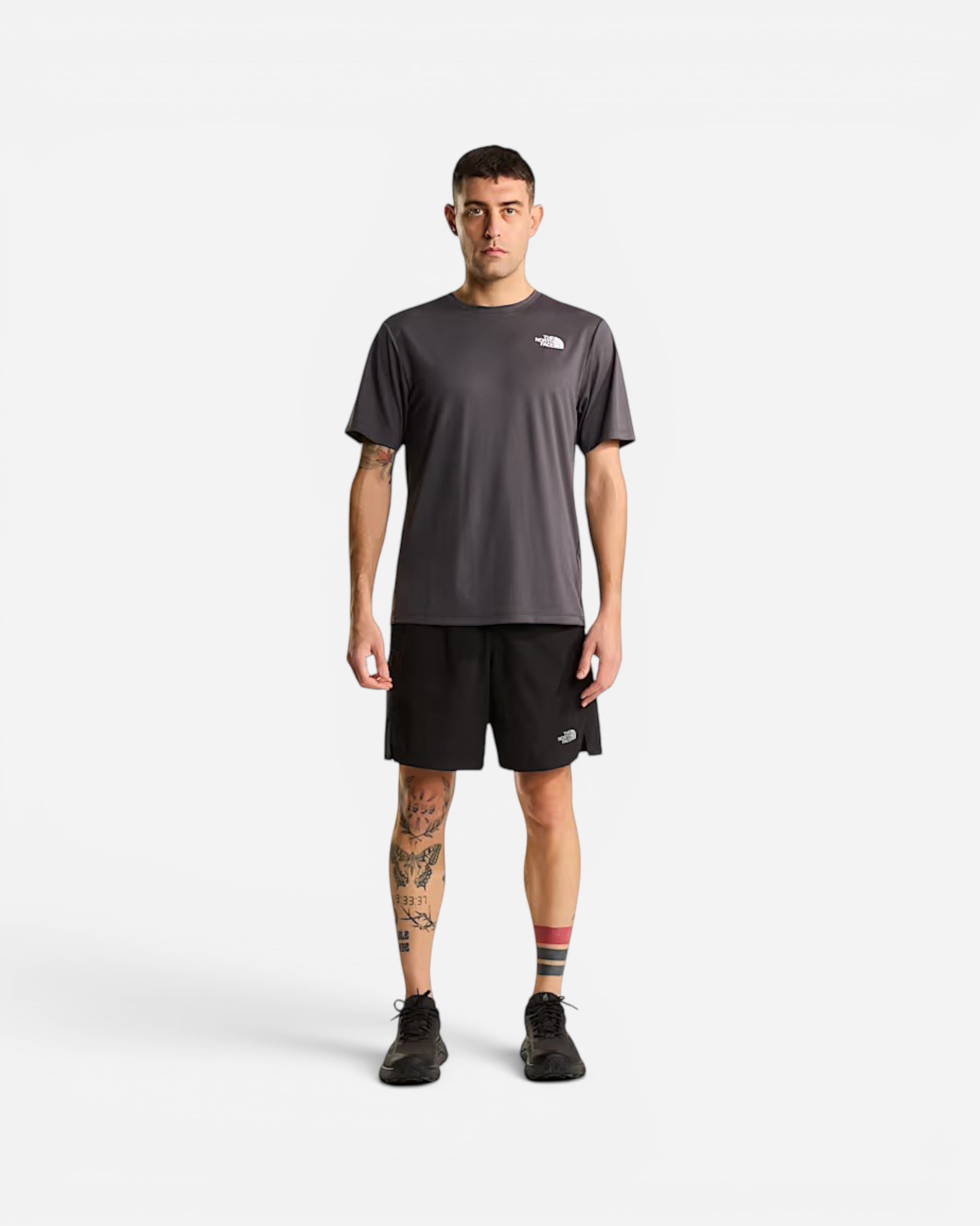 Astrofat model wearing The North Face grey technical t-shirt and black athletic shorts with FlashDry technology.