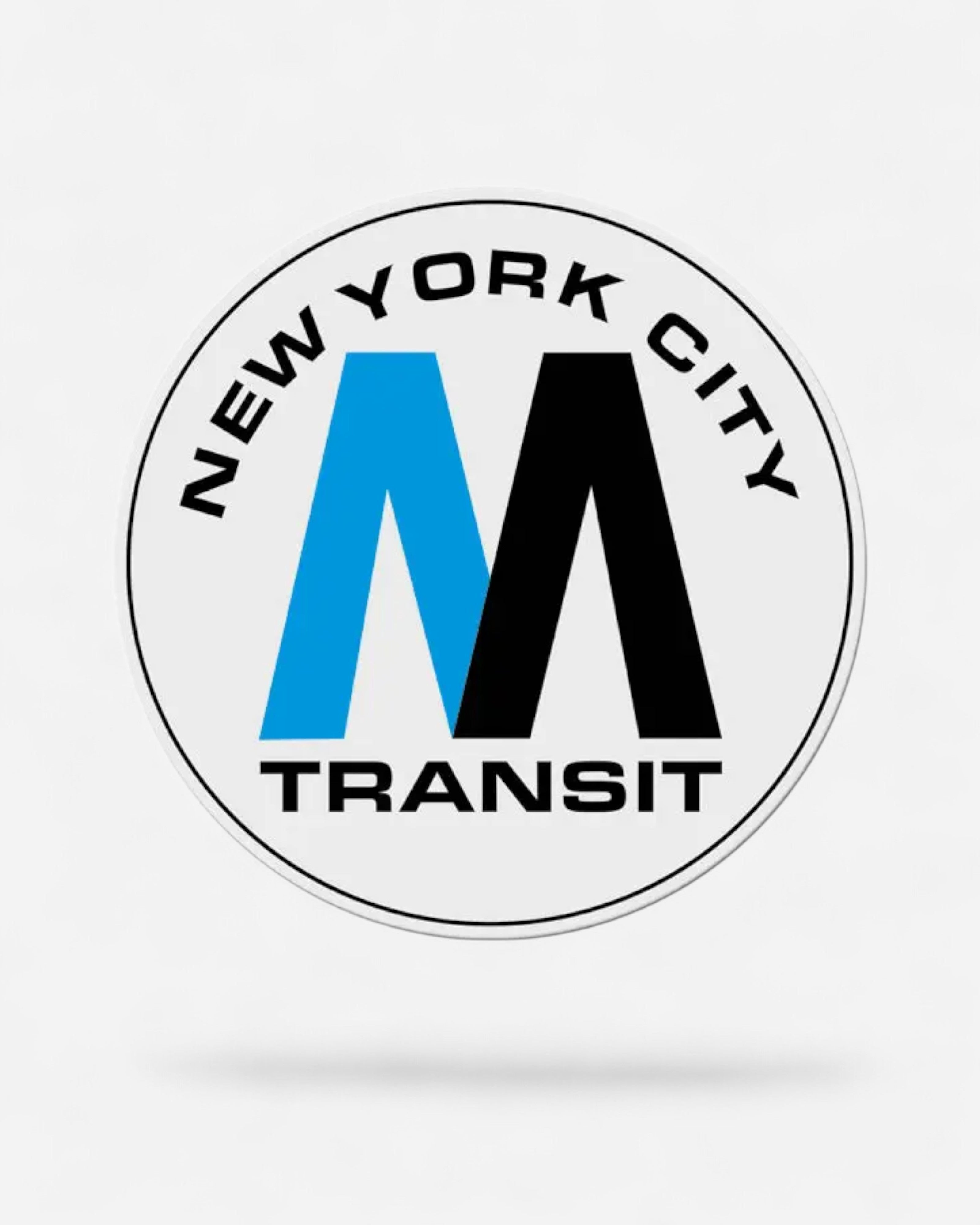 Astrofat XXL New York City MTA subway logo magnet, 45x45cm, featuring the iconic 'M' in blue and black on a white circular background.