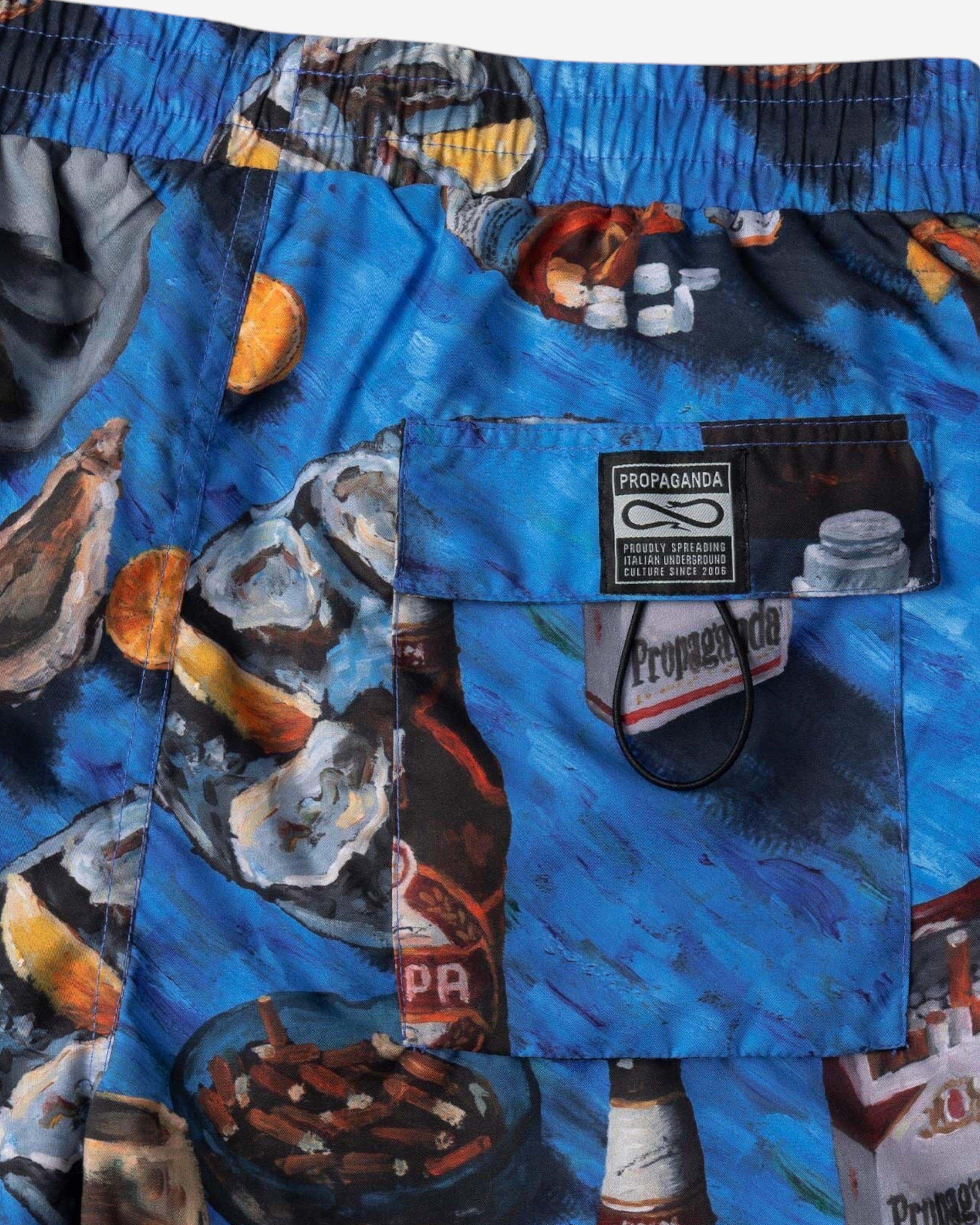 Astrofat Oyster Swimtrunk featuring a blue all-over print with oysters, drinks, and cigarettes, back pocket with label