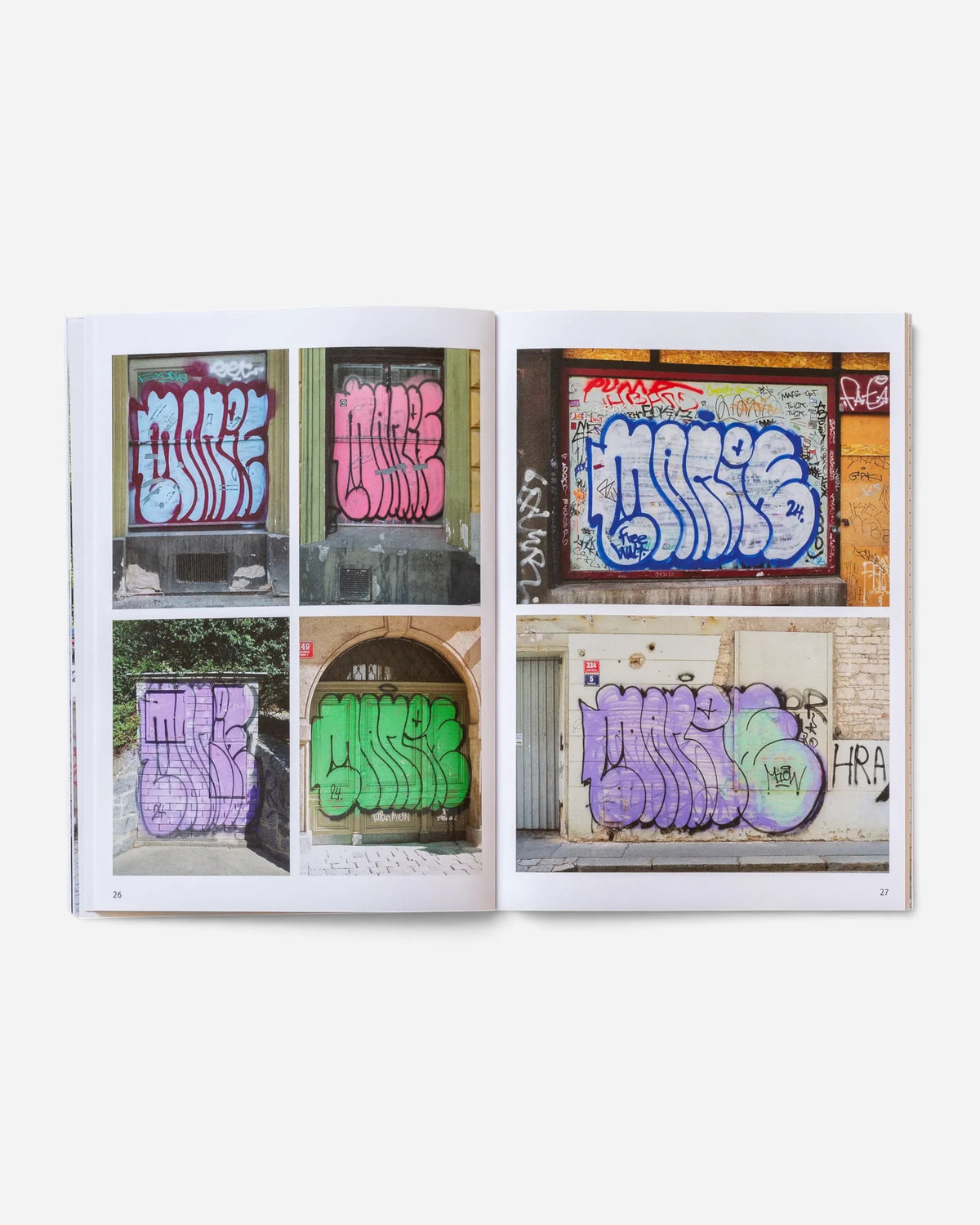 Astrofat Praha Tourist Information zine open to pages showing colorful graffiti throw-ups on Prague city walls.