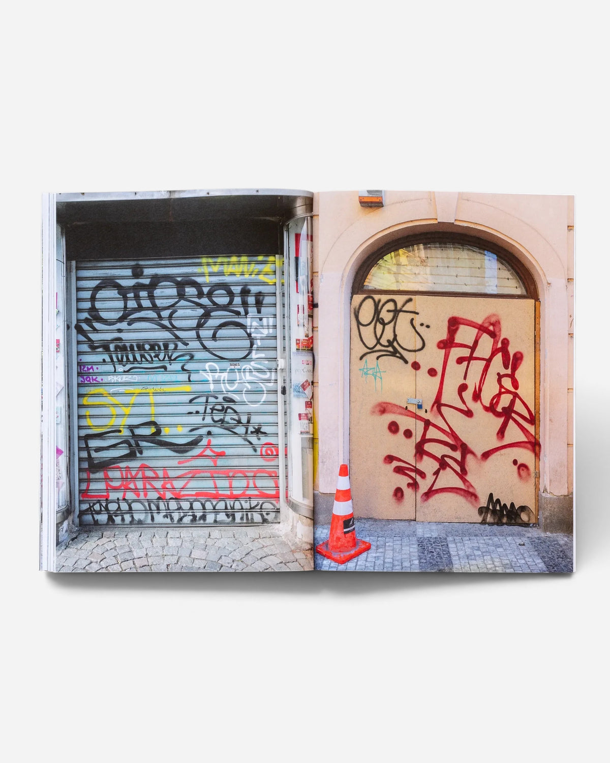 Astrofat Praha Tourist Information zine showing graffiti tags and throw-ups on urban doors and shutters in Prague